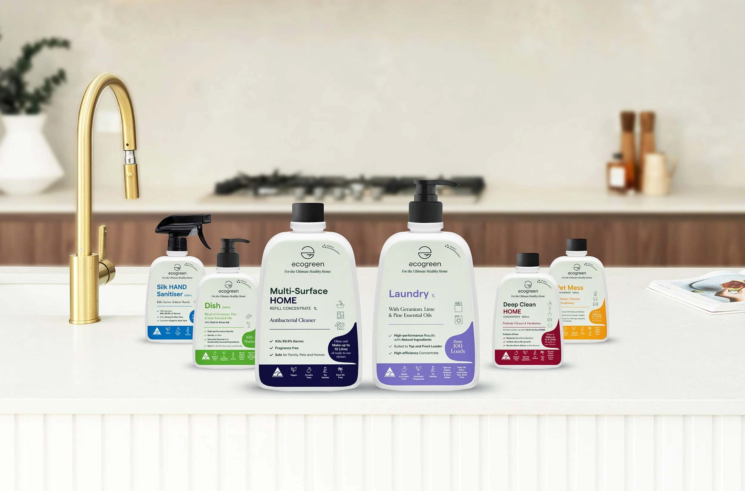 6 Ecogreen home and cleaning products resting on a white marble kitchen bench.