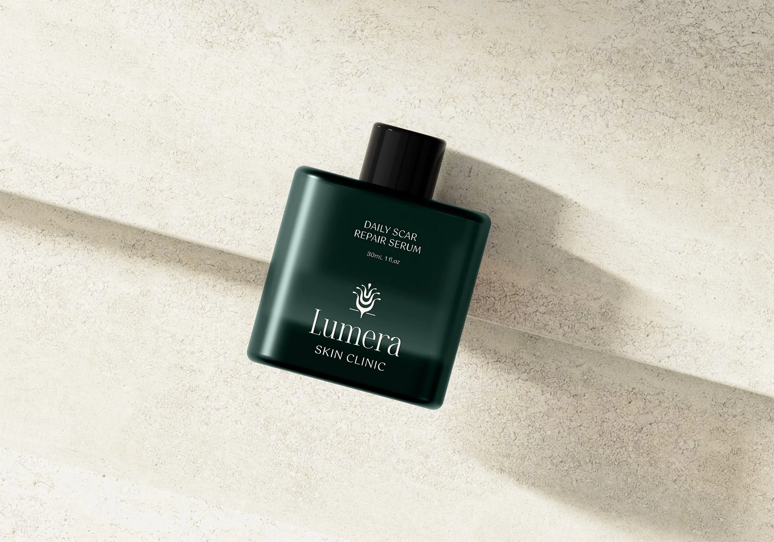 Green bottle of Lumera Skin Clinic scar repair serum, resting on marble surface.