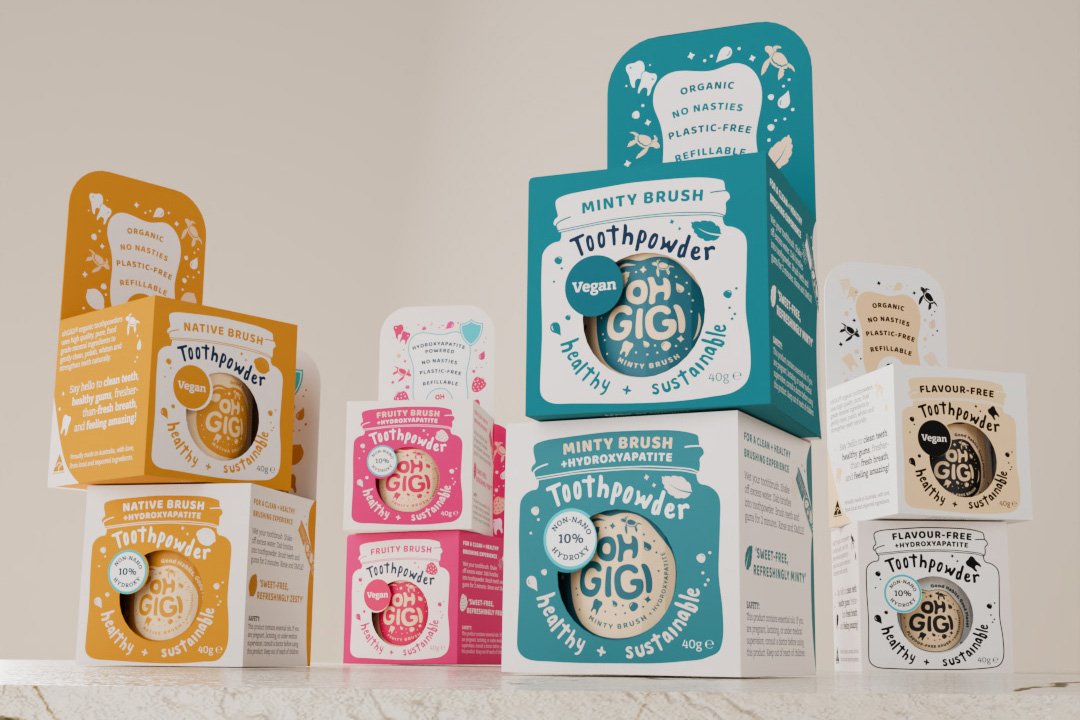 8 ohGiGi toothpowder boxes, stacked in pairs on a marble benchtop.