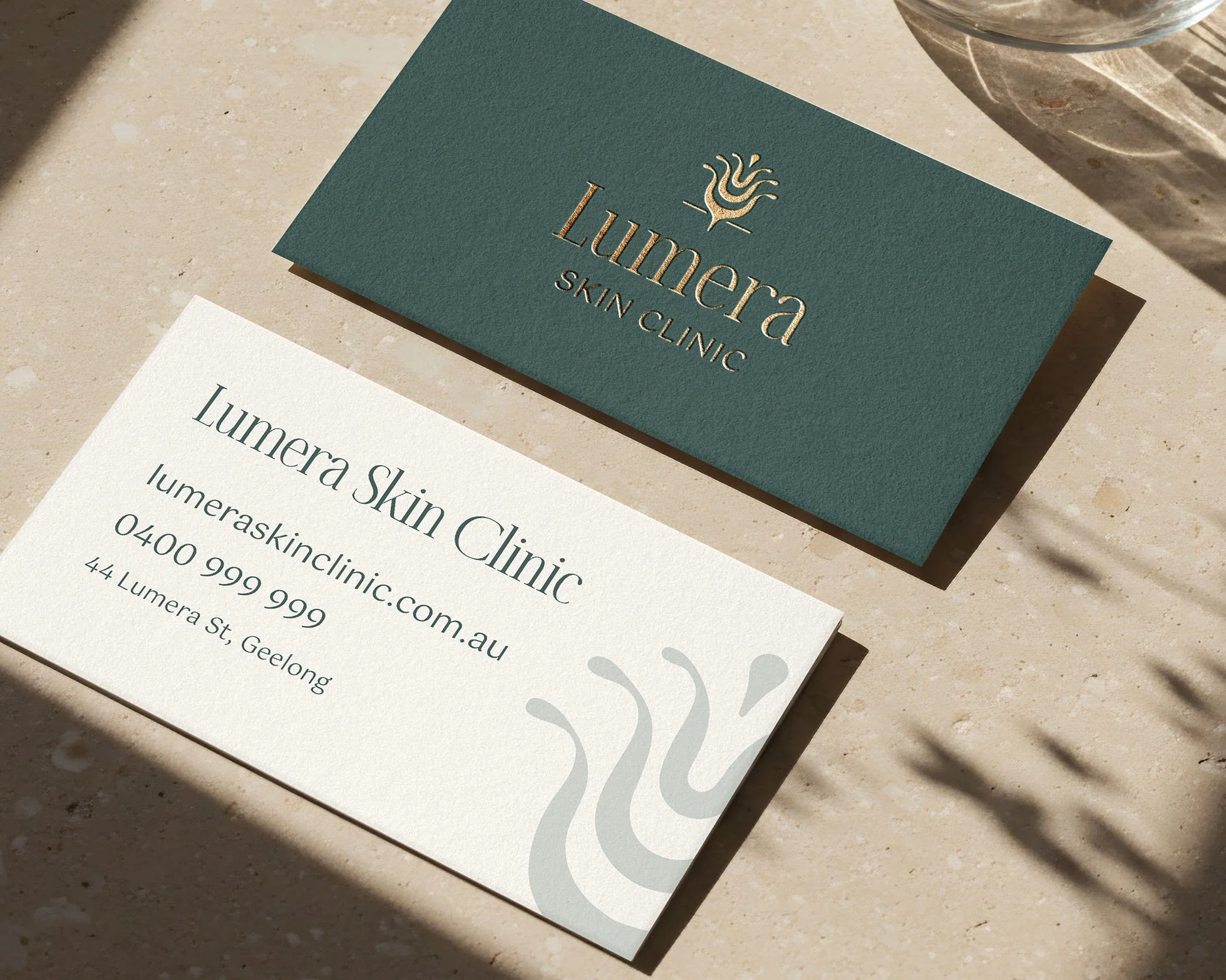 Front and back of Lumera Skin Clinic business card.
