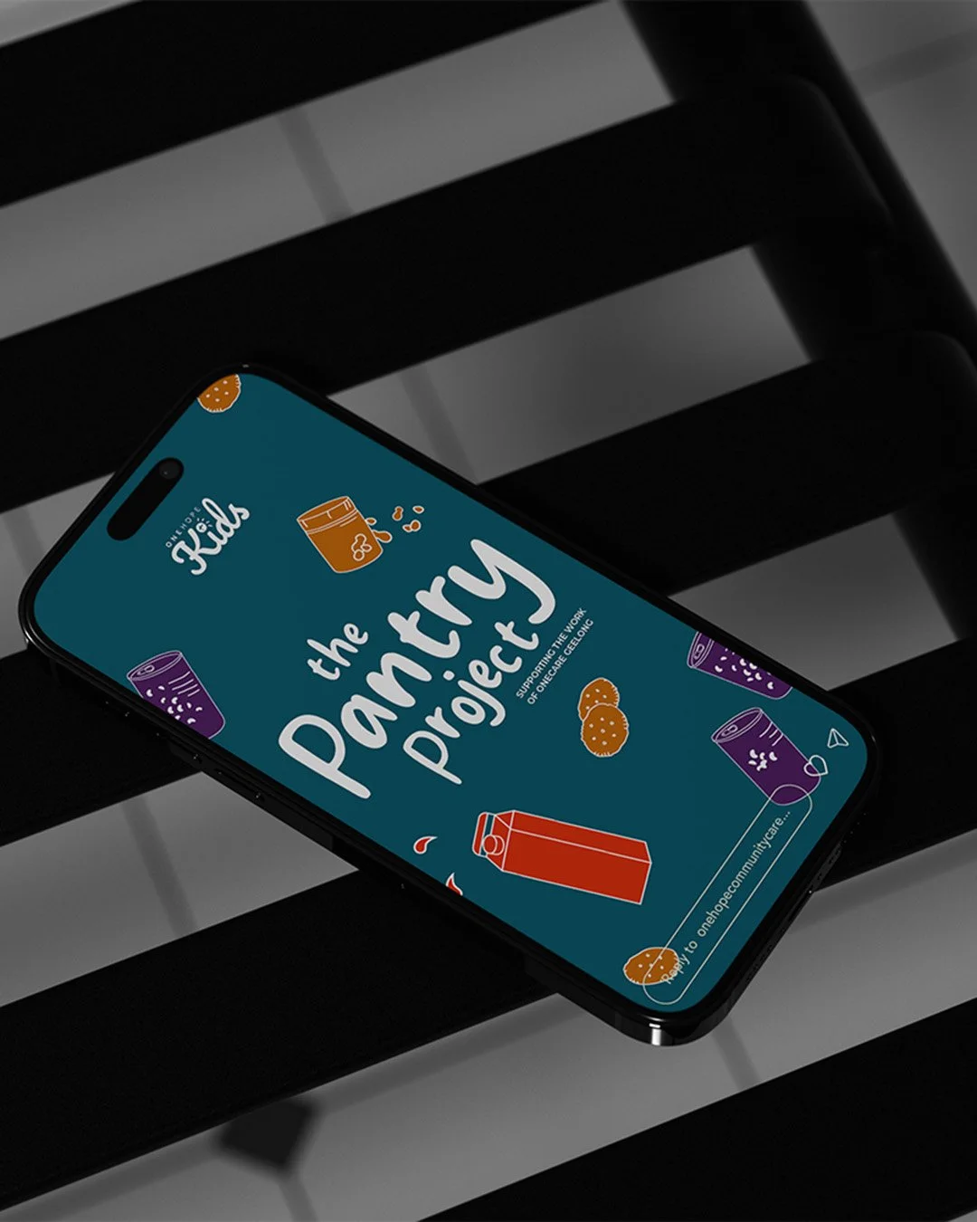 Phone resting on black metal chair, featuring an Instagram story of the Pantry Project on its screen.