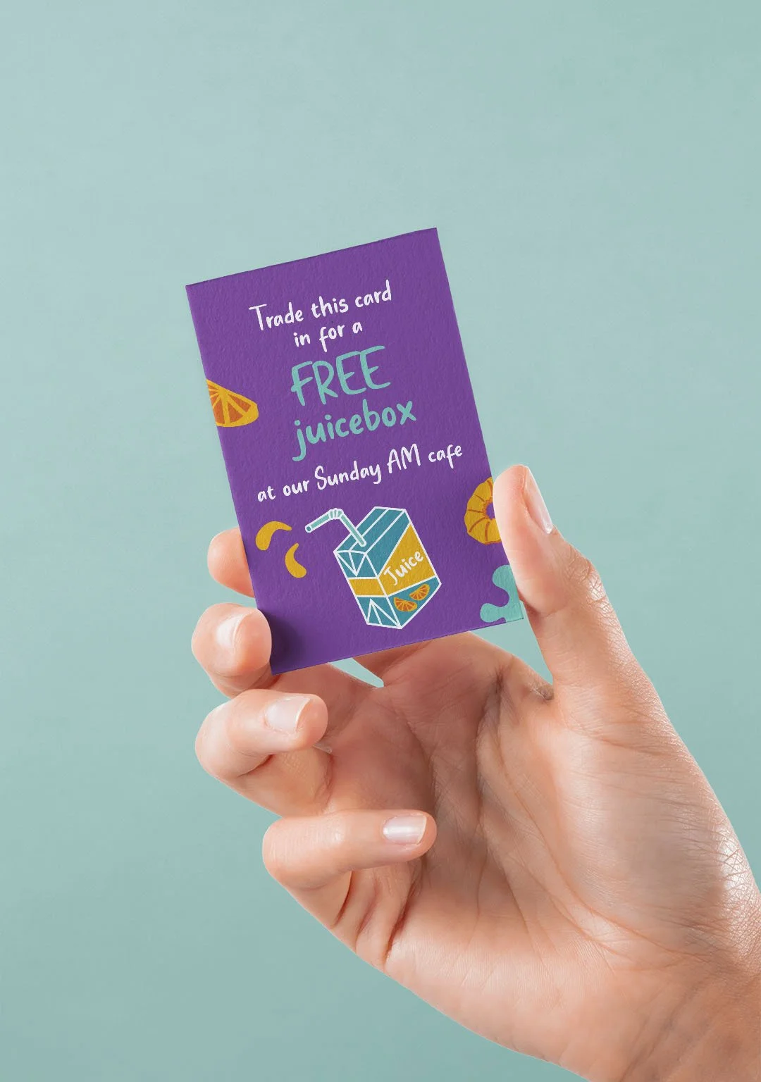 Hand holding a small card for a free juicebox.