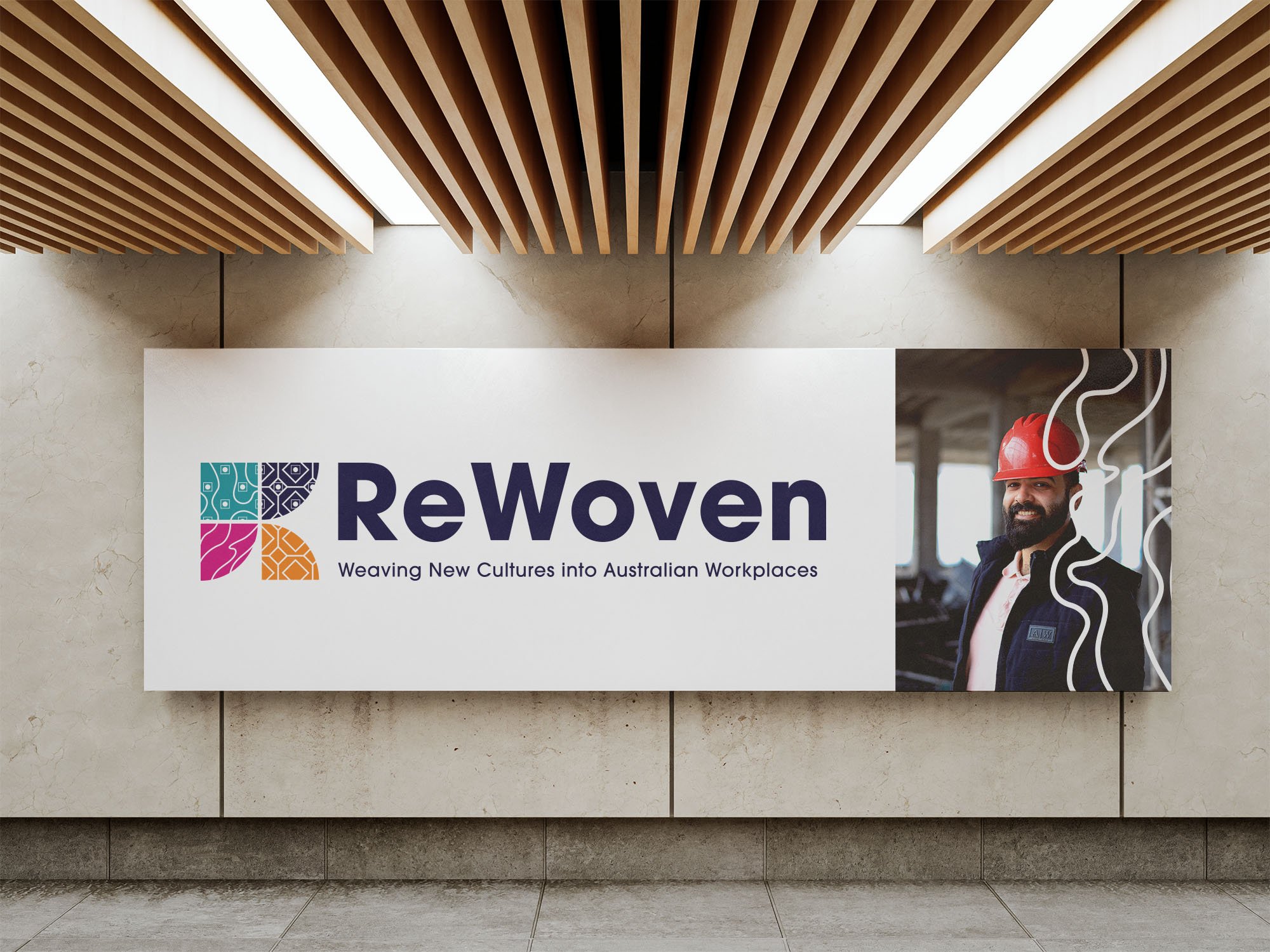 A large, horizontal sign advertising ReWoven employment services, with a photo of a labourer.