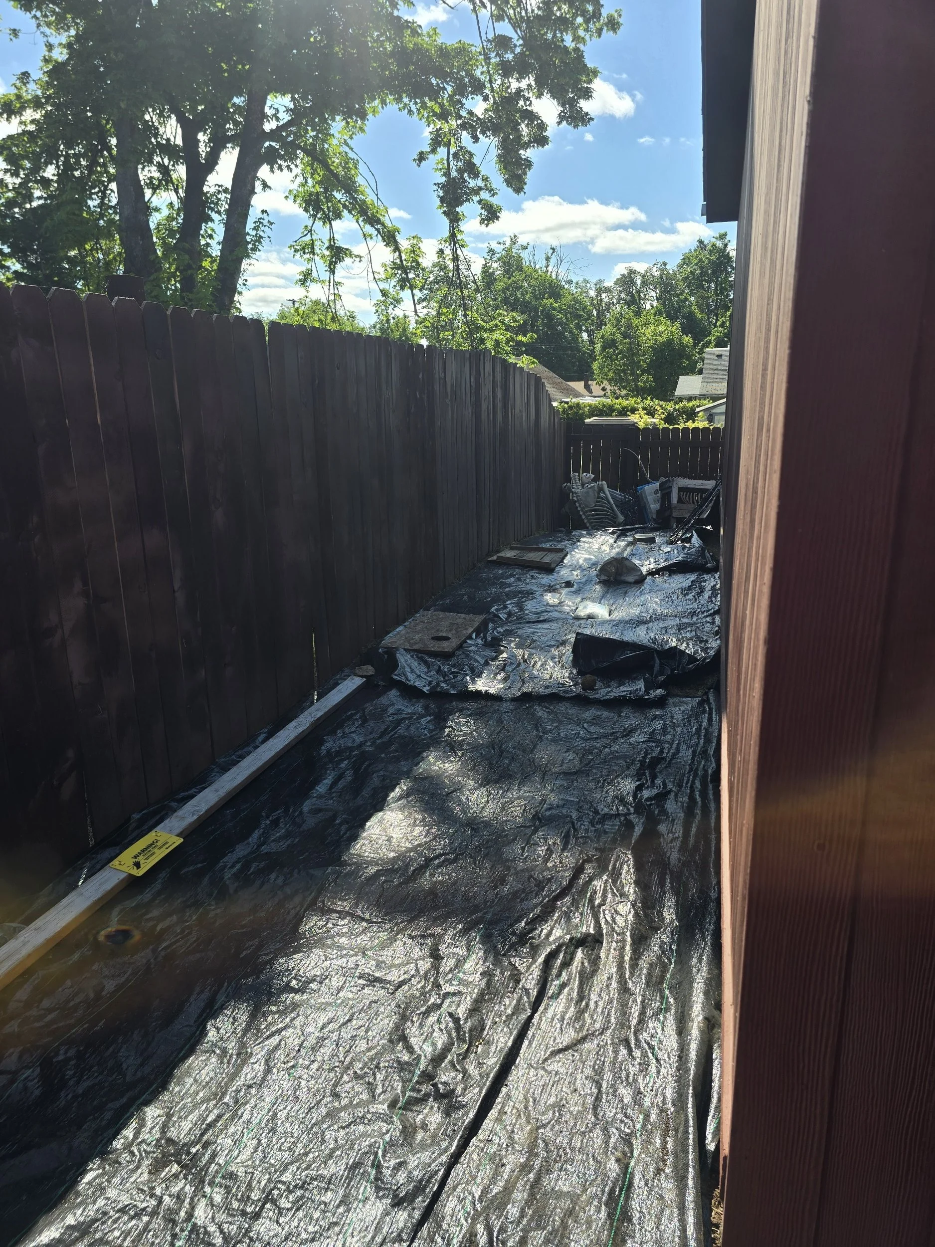 Narrow side yard before flagstone walkway installation in Springfield, Oregon