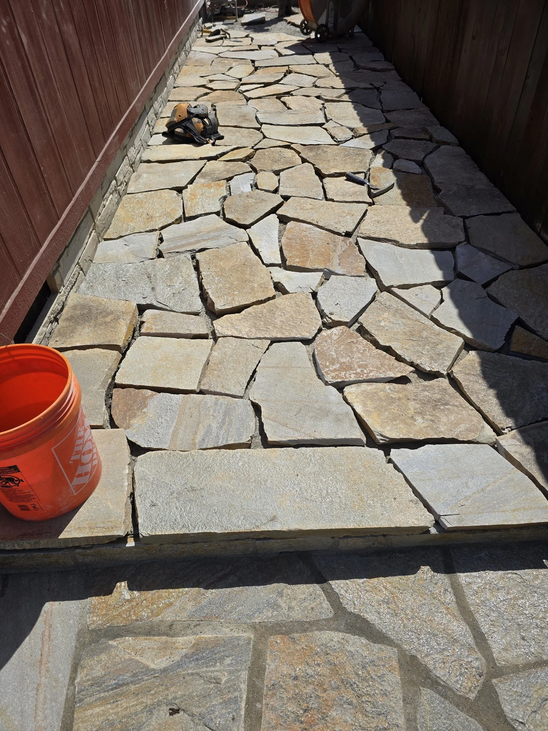 Sunset Gold flagstone being mortar-set during walkway installation