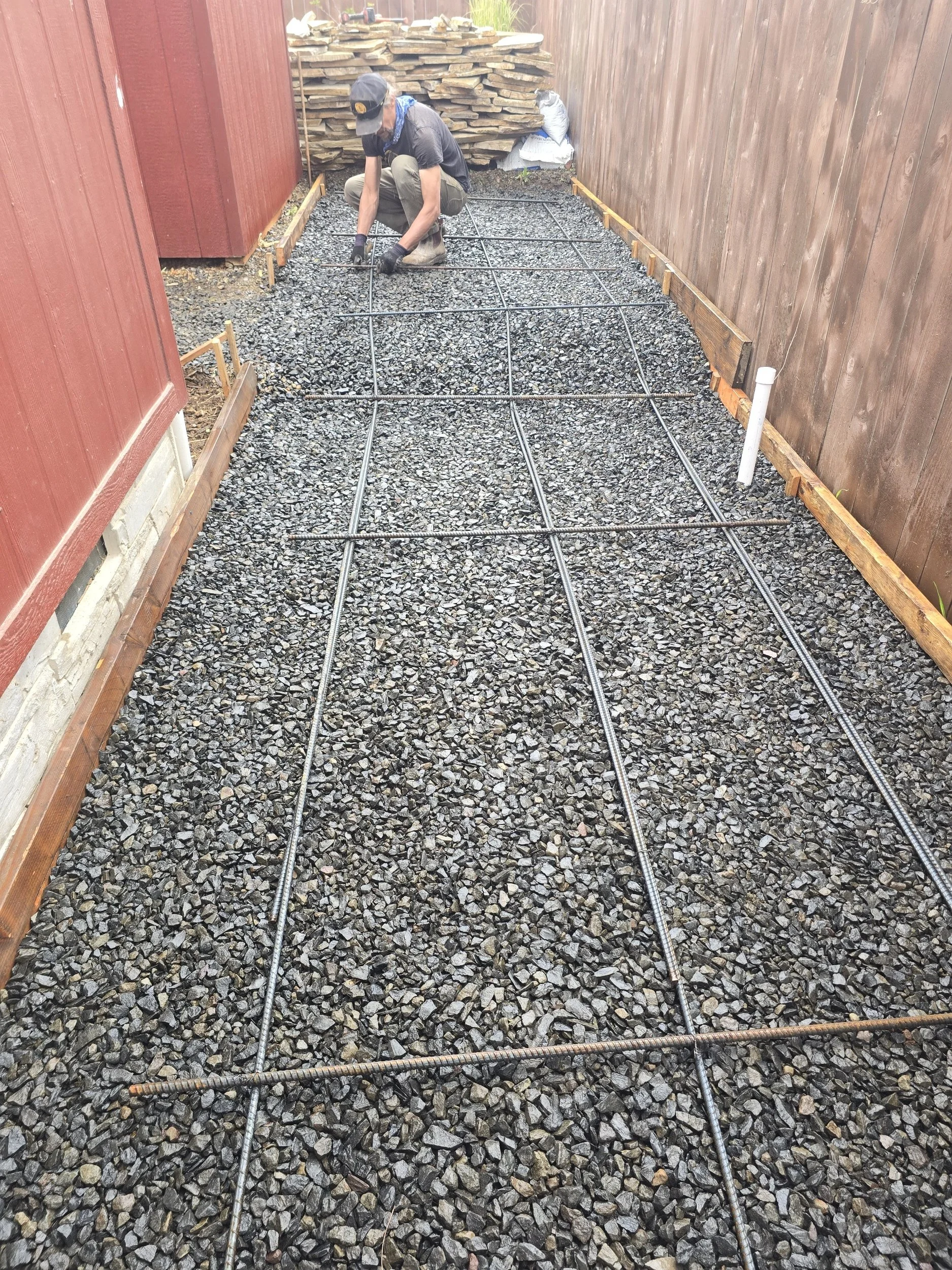 Rebar reinforcement over compacted gravel base before concrete pour