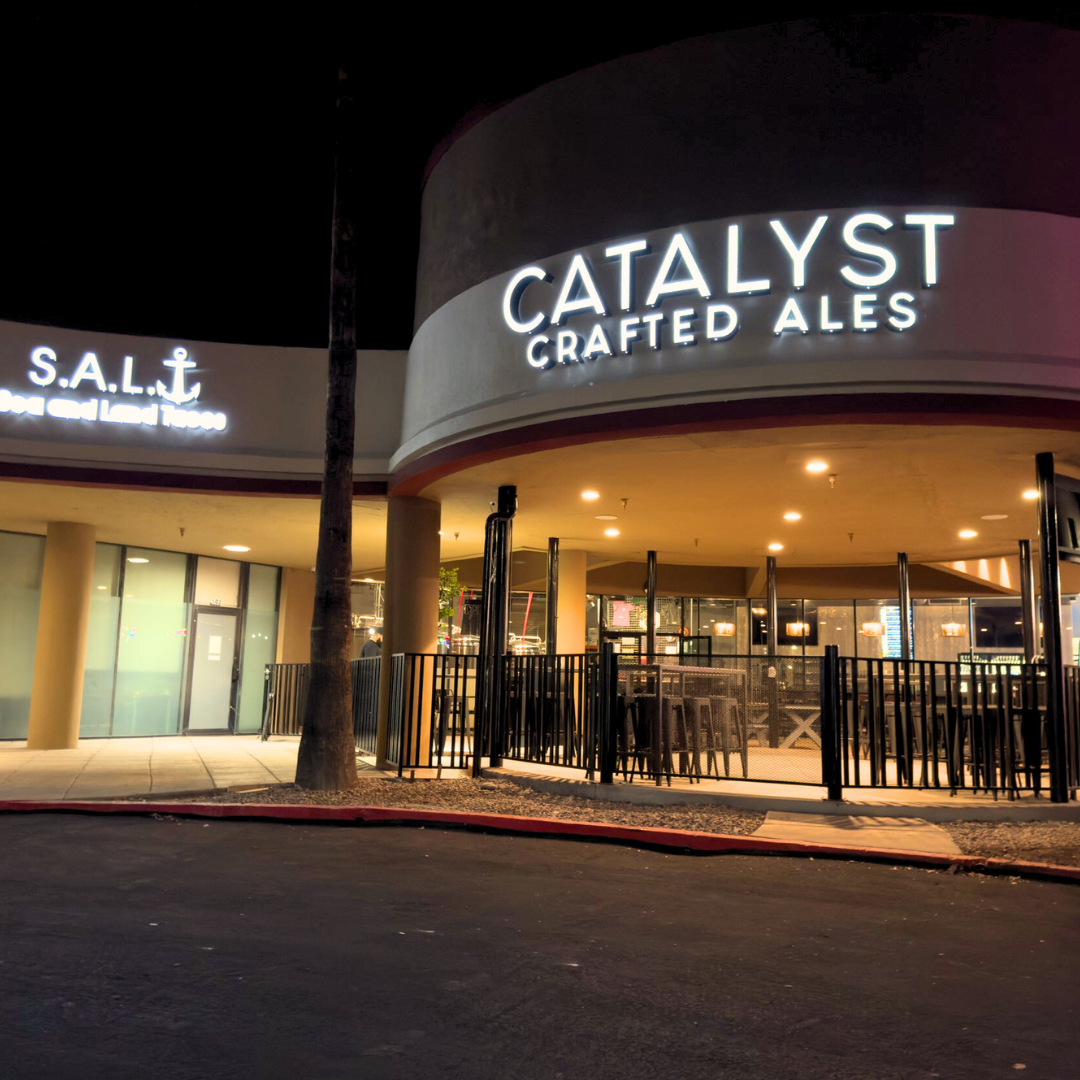 The inviting facade of Catalyst Crafted Ales, illuminated at night, beckoning visitors to enjoy a refreshing craft beer.