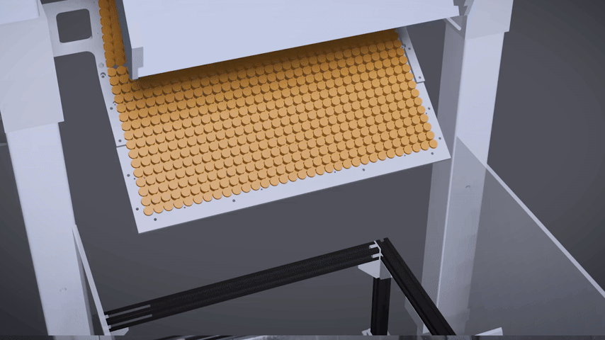 A machine with a conveyor filled with brown, circular objects being dispensed or sorted.