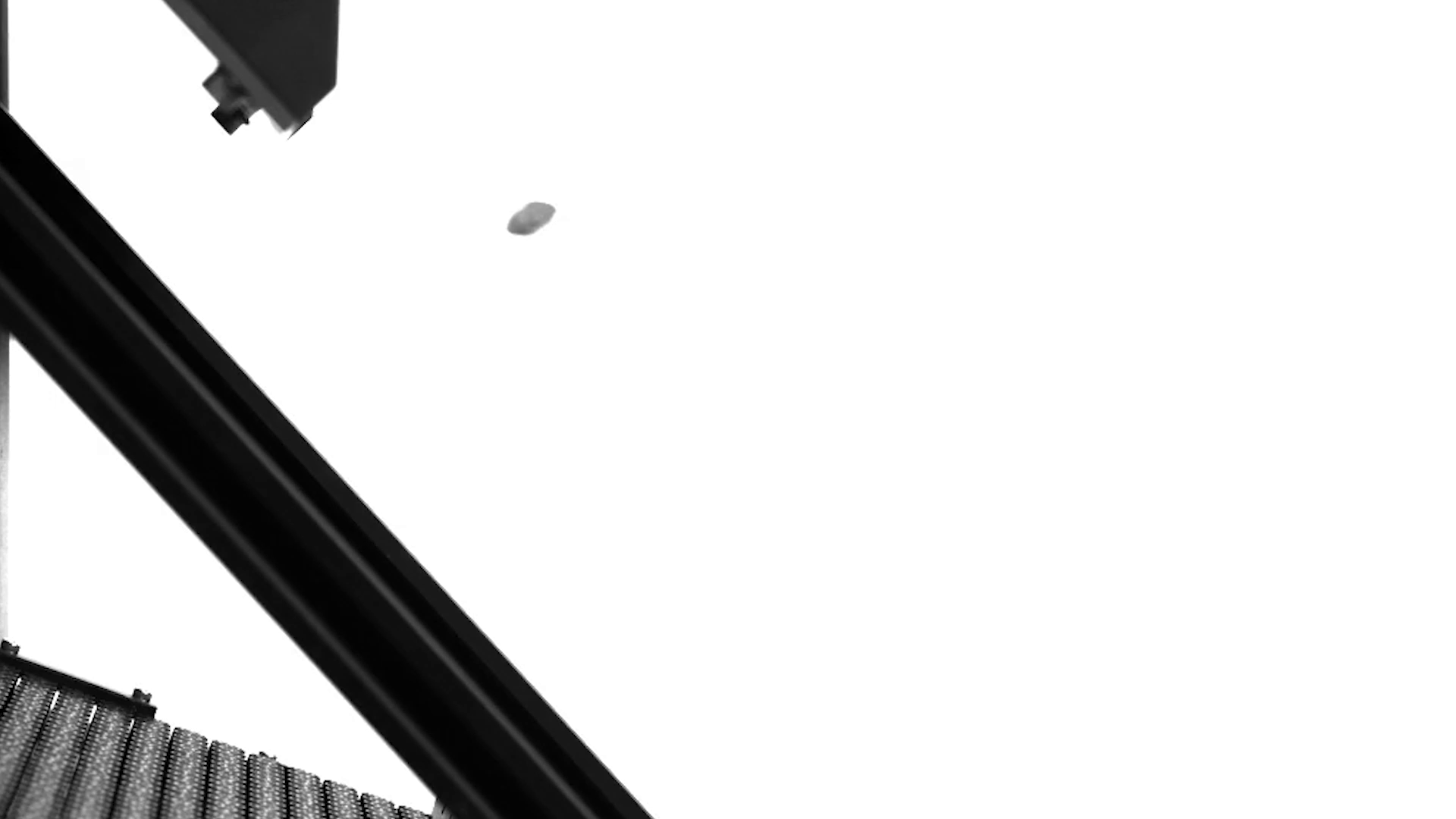 Close-up of a conveyor belt made of metal rollers with a black metal framework, set against a white background.