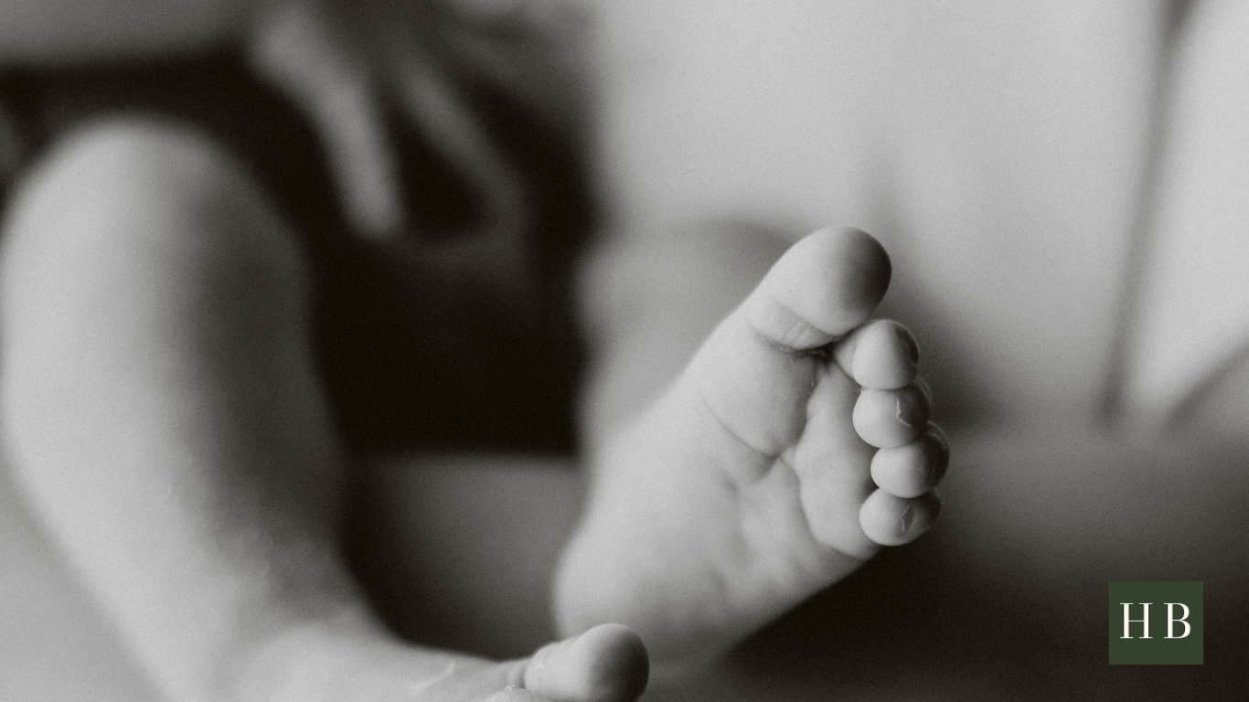 Expectant father installing car seat and preparing baby gear