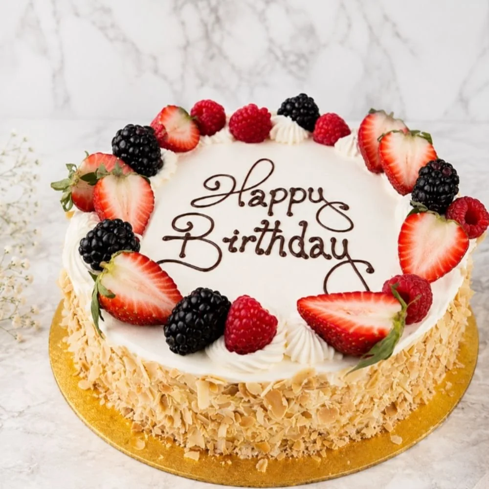 Fresh Cream and fruit Gateau with Happy Birthday pipping