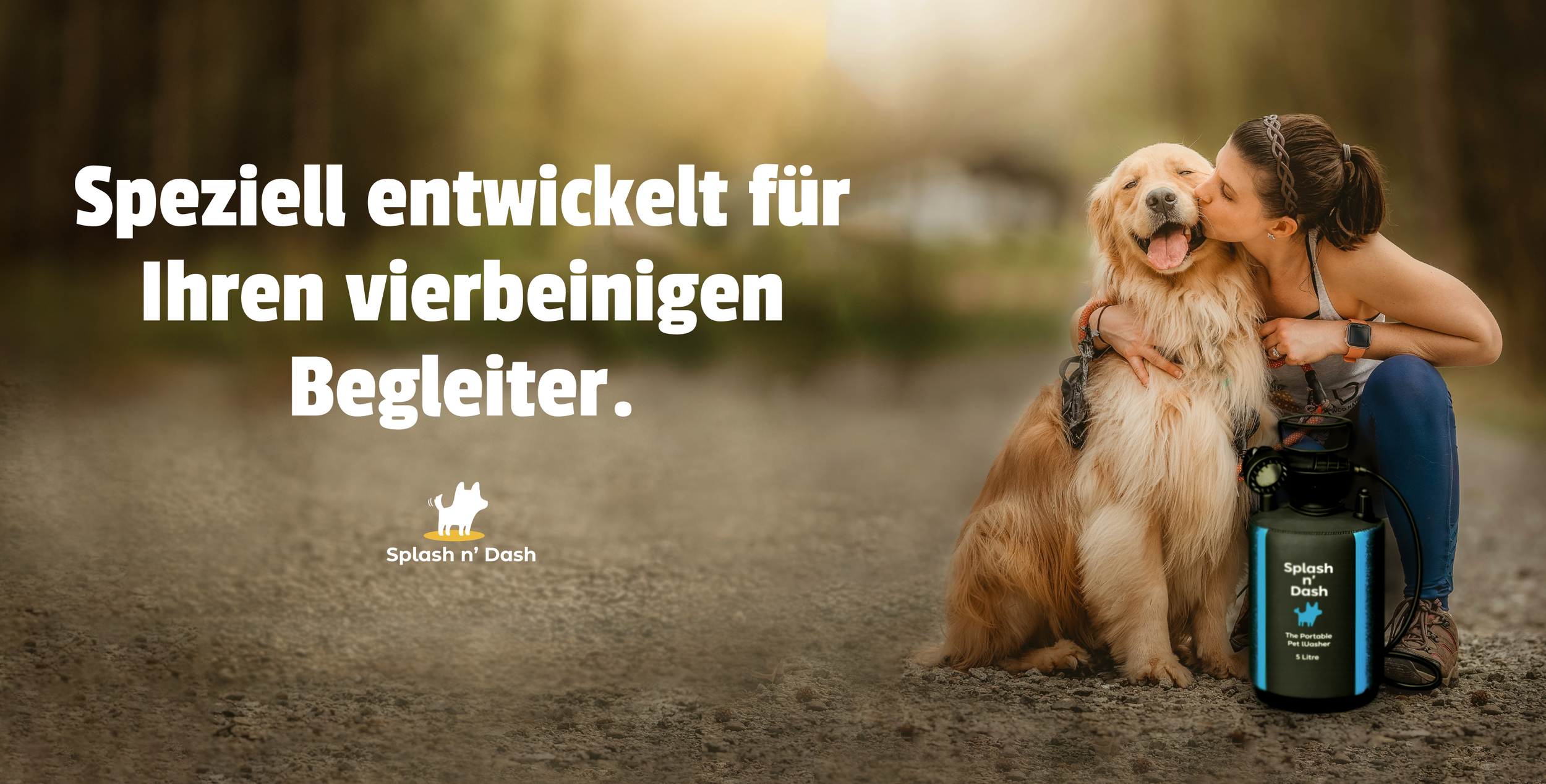 A woman kisses her Golden Retriever on a trail in a forest during autumn, next to a portable pet washer labeled 'Splash n' Dash' with a black and blue design.