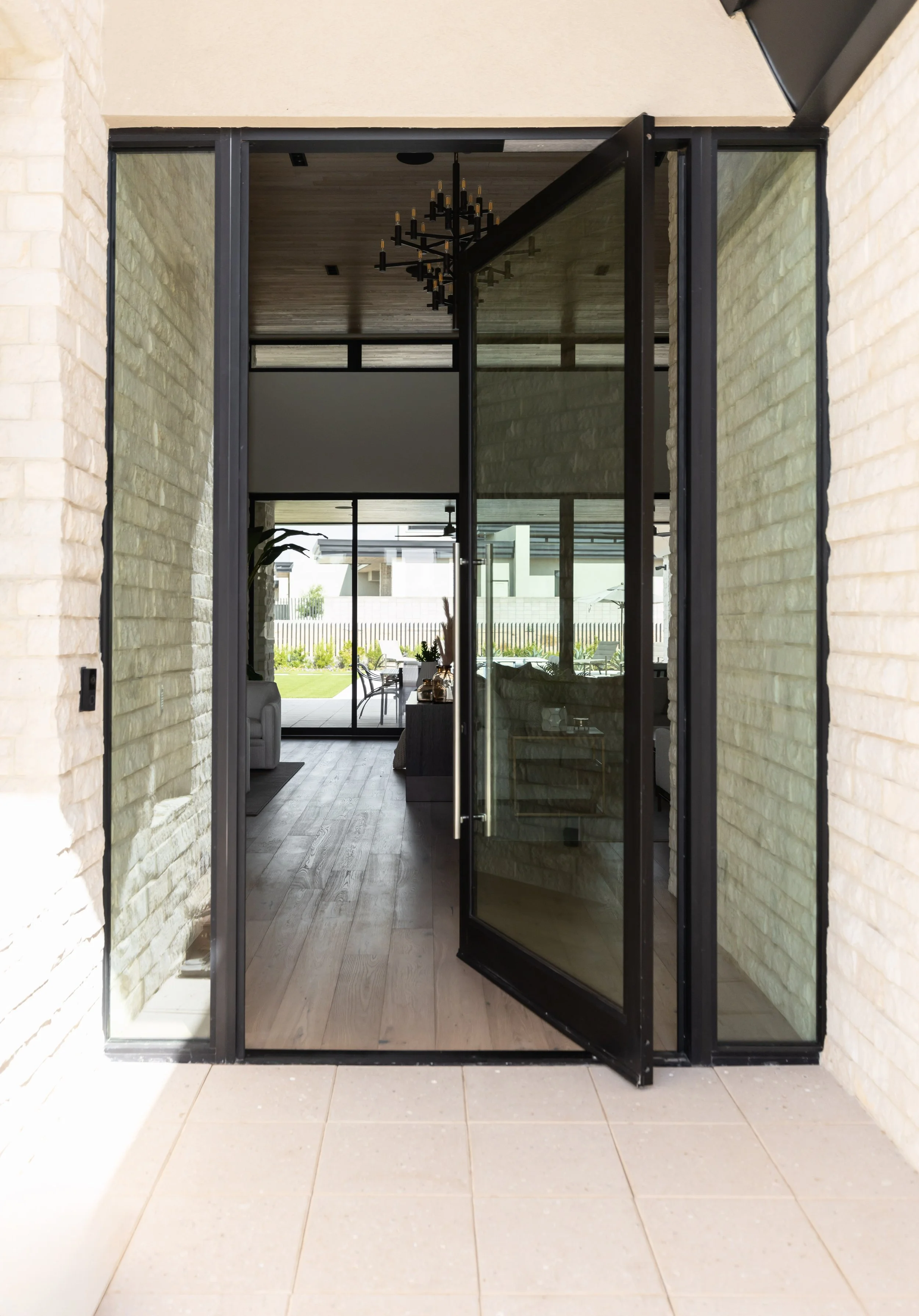 Light wood flooring and natural stone walls in a modern Scottsdale custom home.