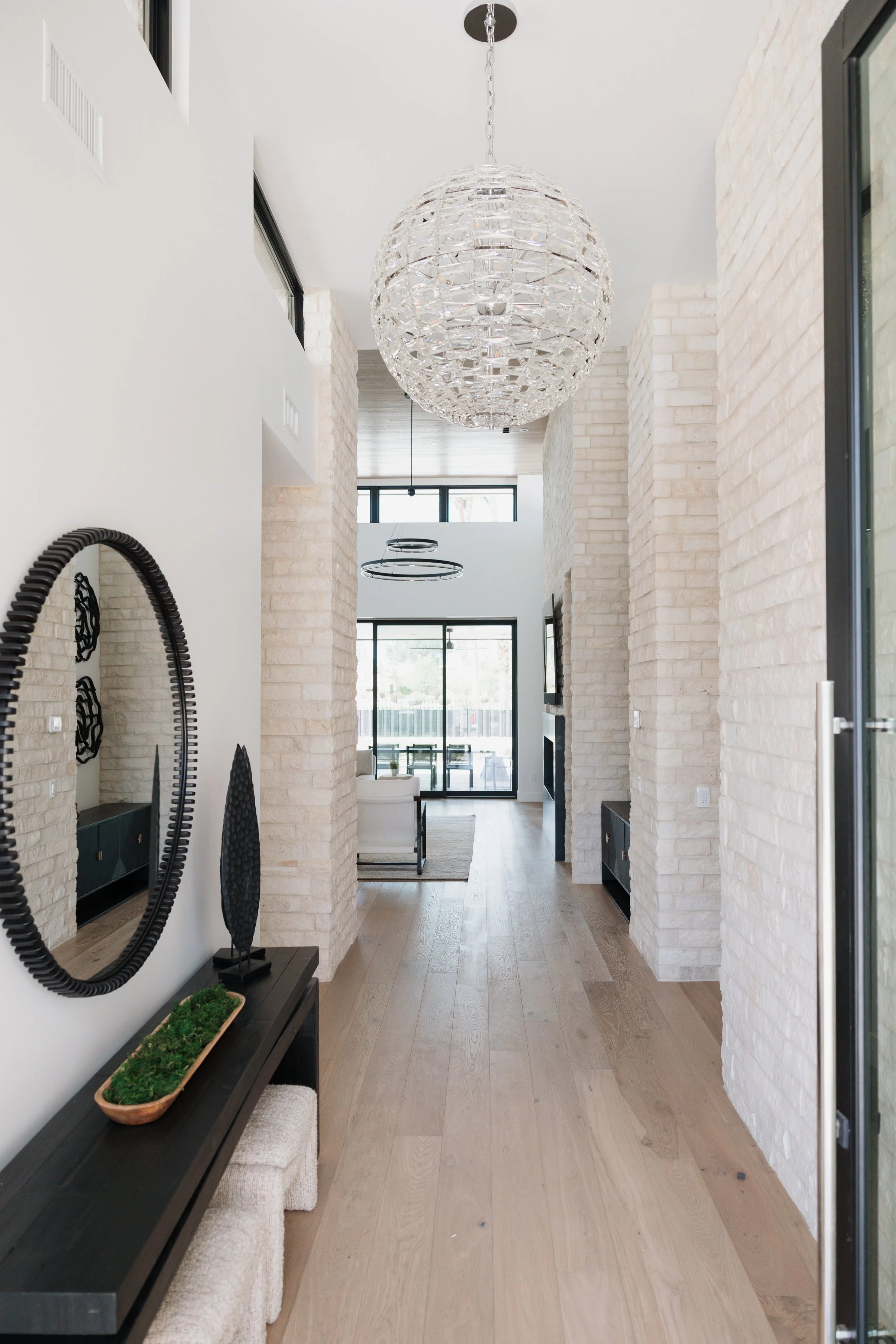Scottsdale custom home entryway with statement chandelier and stone walls