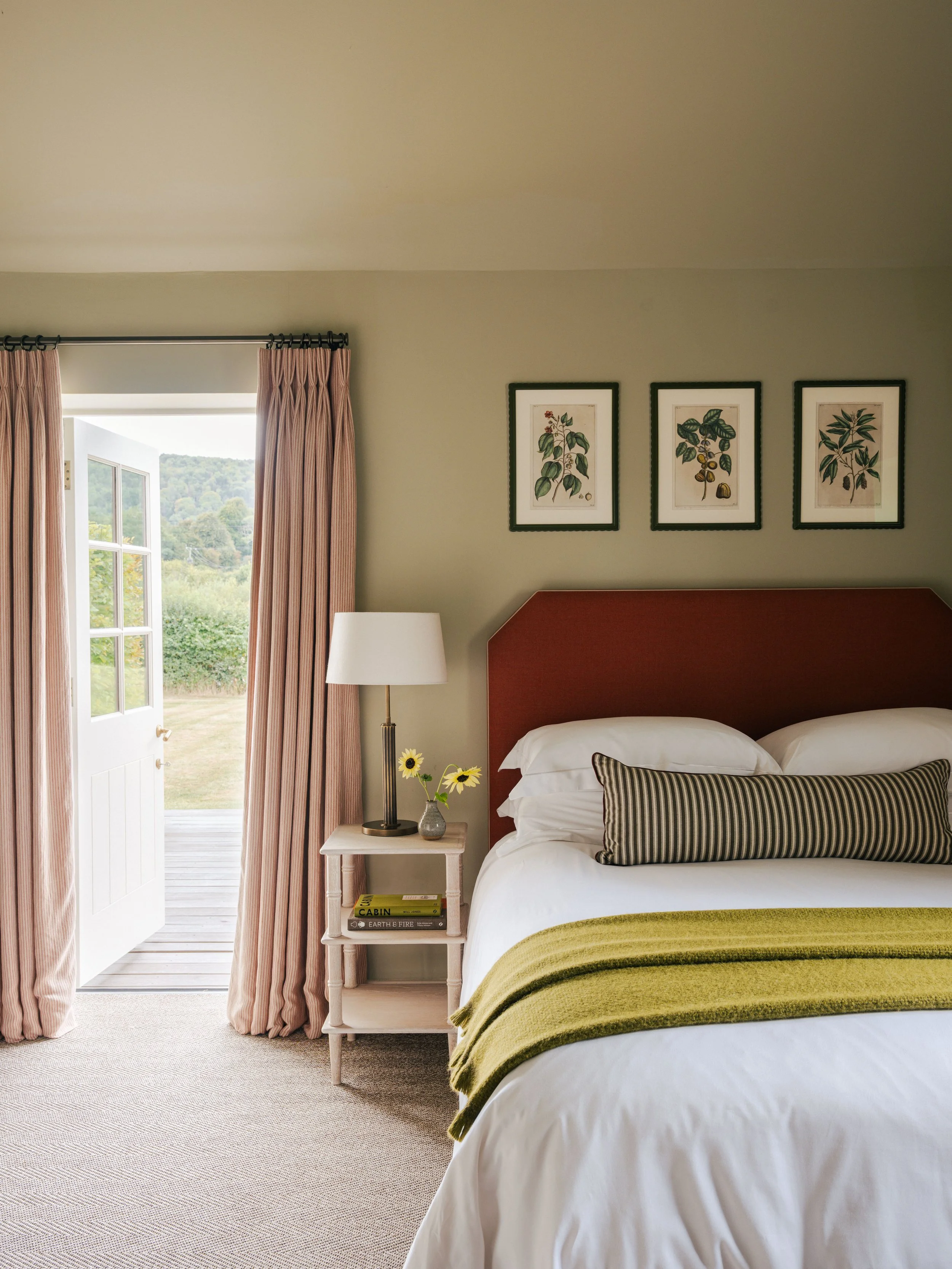 Luxury accommodation at The Woodcote showing a stylishly decorated bedroom with garden access and country-style interiors.