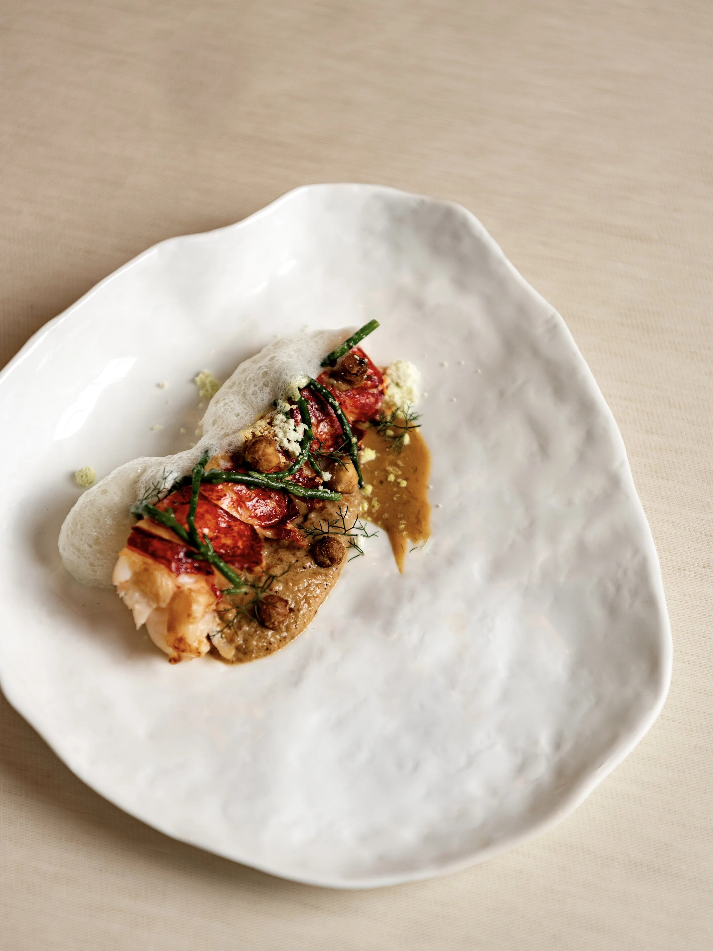 Gourmet lobster tail with sea samphire and sauce, part of the Valentine’s Day tasting menu at The Woodcote.