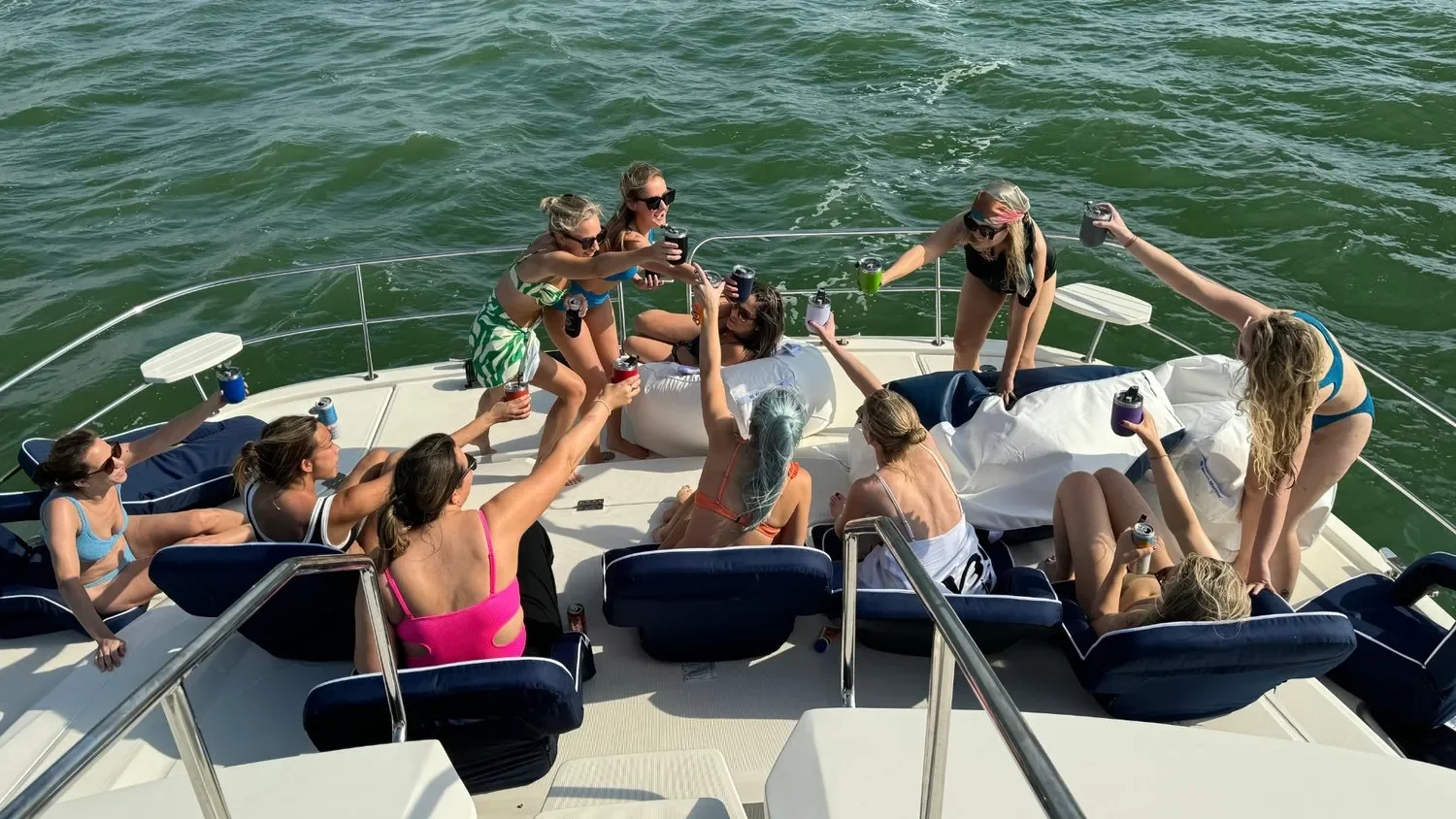 things to do in Anna Maria – Party in Style – group of friends celebrating aboard a private yacht with drinks and music.