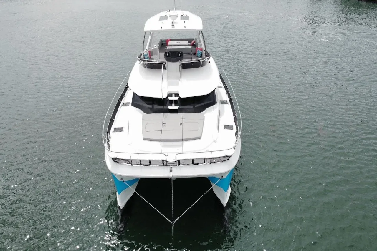An aerial view of a large white yacht floating on a body of water.