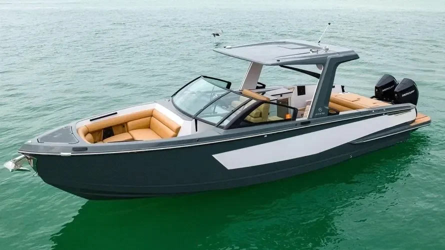 kokomo charters - 35' Ocean Rode - A sleek motorboat with tan seating and a protective canopy on calm green water.