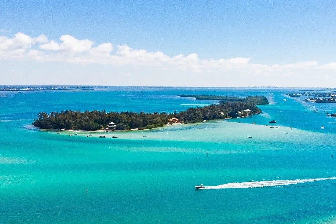 things to do in Anna Maria – Jewfish Key – panoramic aerial of Jewfish Key’s waterfront homes and blue Gulf waters.