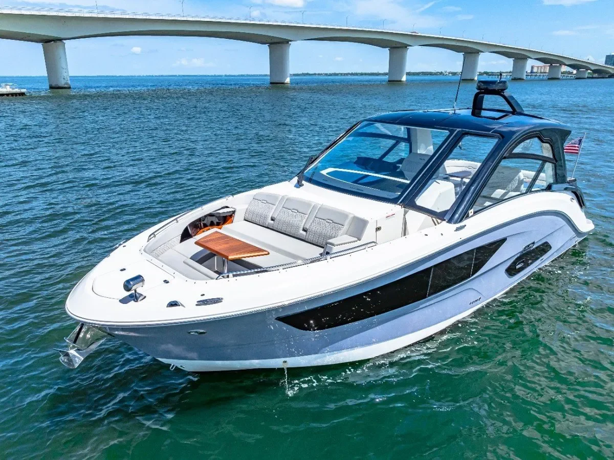 kokomo charters - 40' Golden Ticket - A white and black luxury boat on the water with a bridge in the background