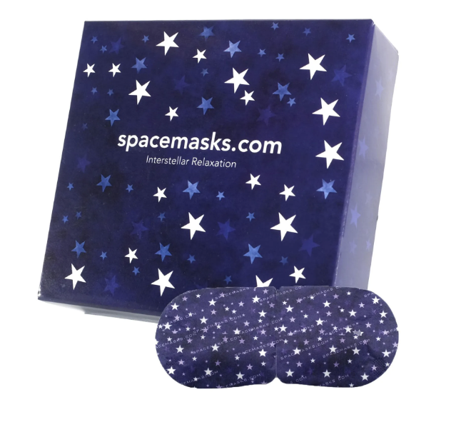 A box labeled spacemasks.com with stars on it and a pair of star-patterned sleep masks in front.