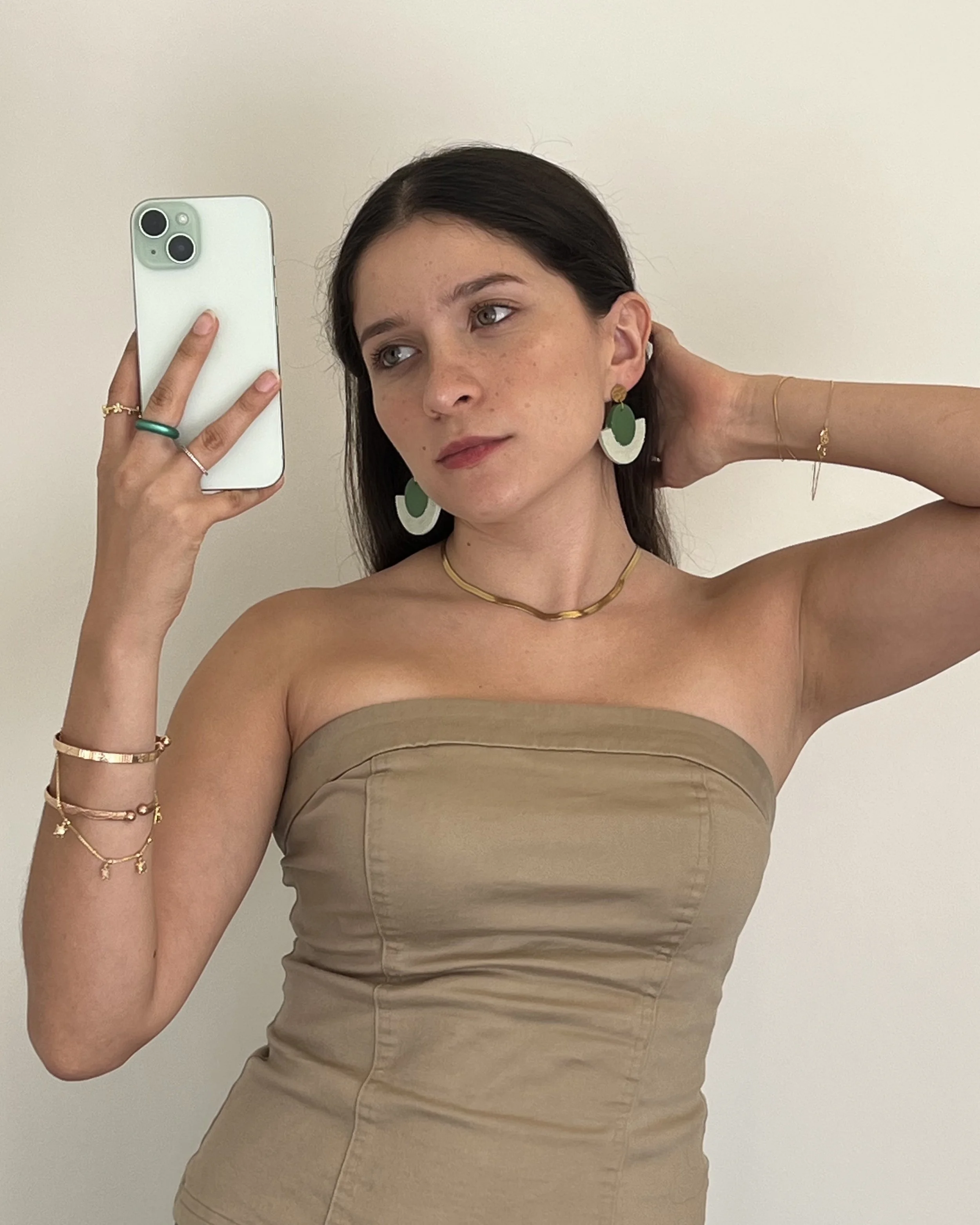 wearing green earrings traces.jpeg
