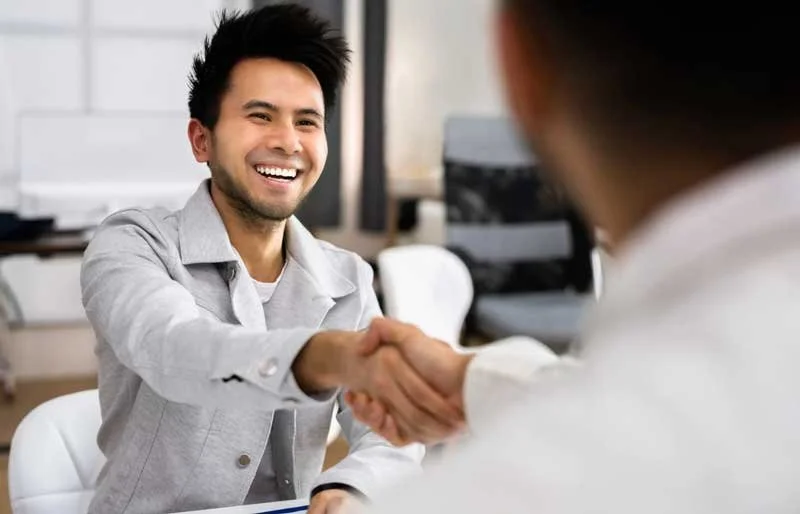Prepared interviewee shaking hands with interviewer during the hiring process