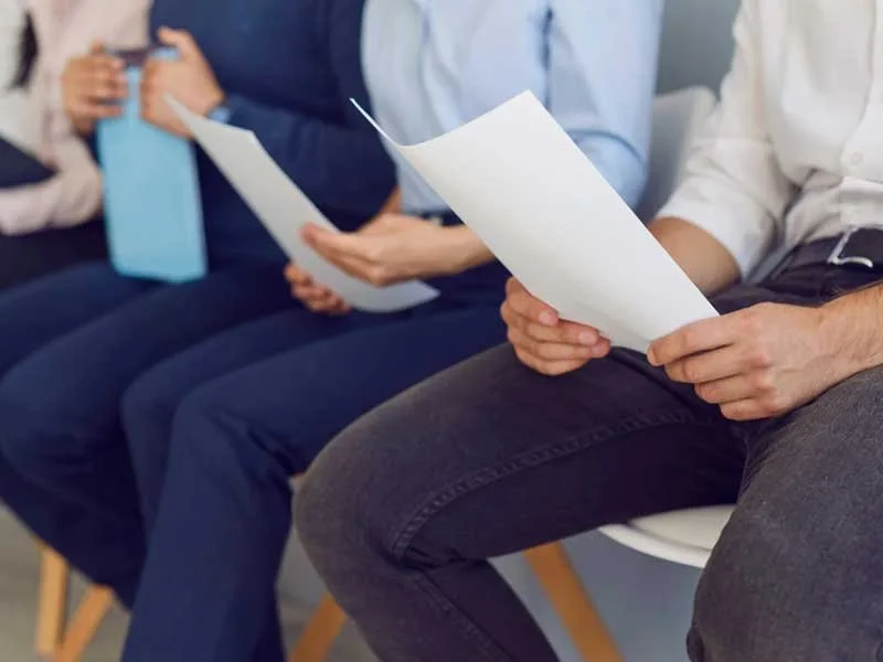 Applicants holding resumes and waiting for interviews