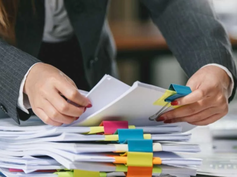 Business owner sifting through HR documents themselves