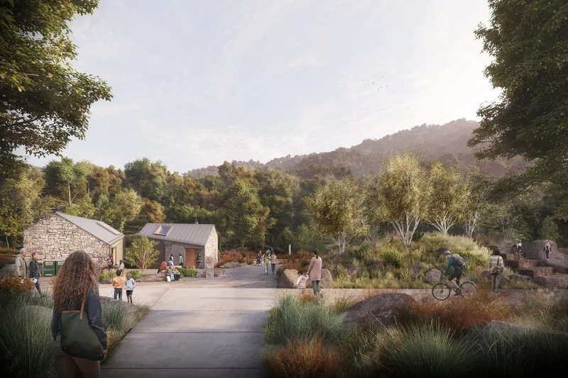 Concept rendering of planned improvements at Breakneck Ridge: Scenic outdoor area with paths, people walking and cycling, small restroom buidlings, and greenery. Background of trees and hills under a clear sky.