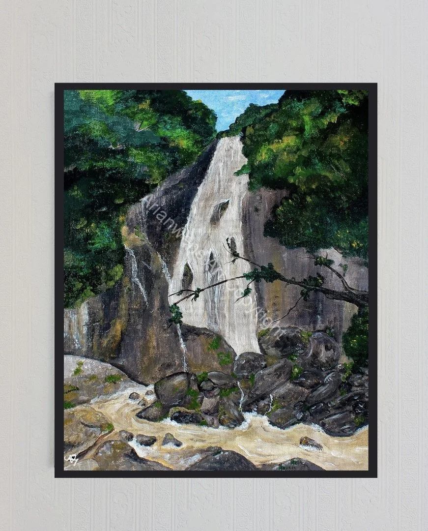 An original acrylic painting of a waterfall amongst big boulders surrounded by lush green trees