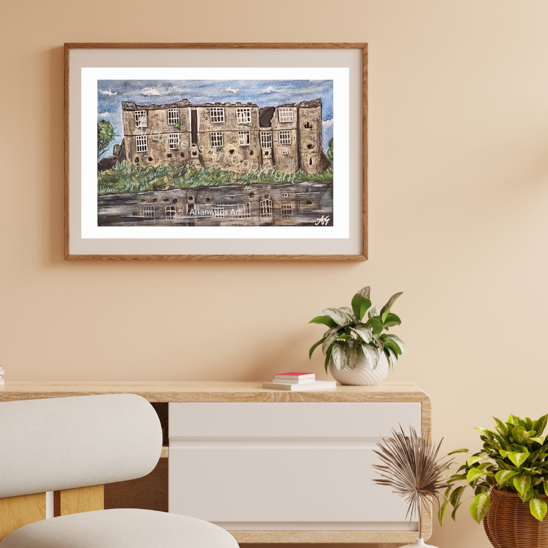 A watercolour painting of an old castle with windows and beige coloured brick overlooking a calm river with a blue sky in the background
