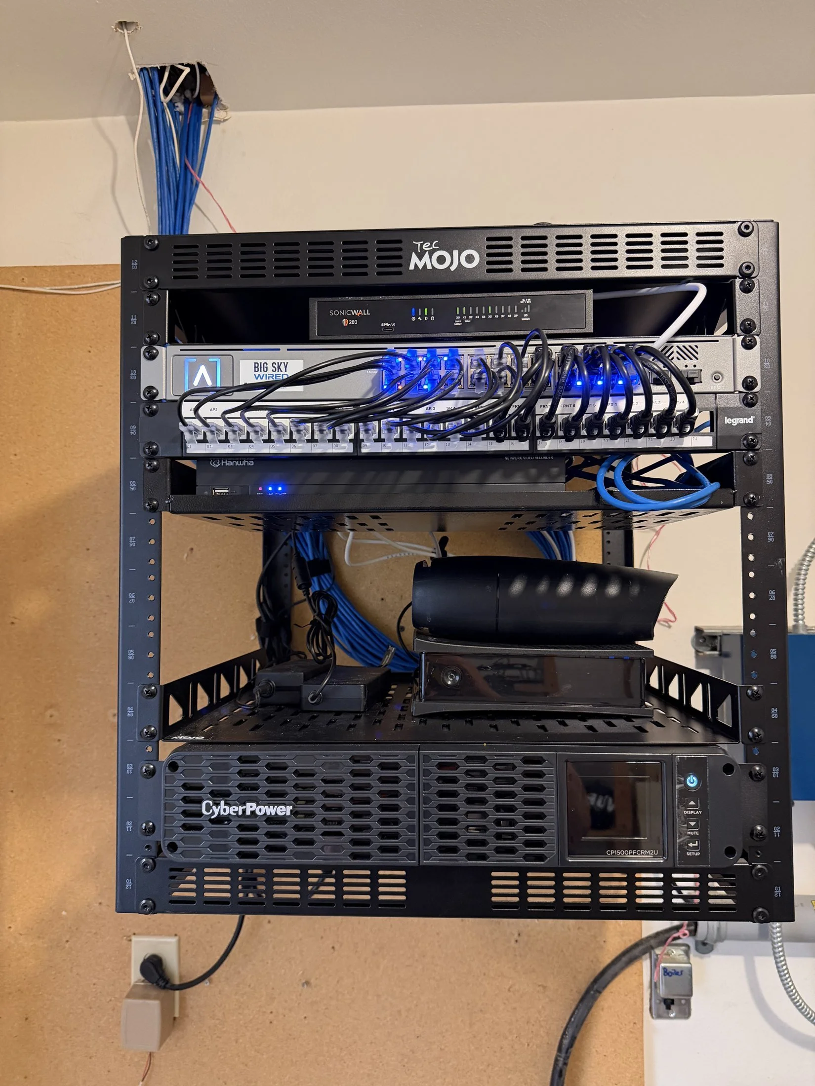 Network rack with firewall, Alta Labs switch, patch panel, and CyberPower UPS installed by Big Sky Wired