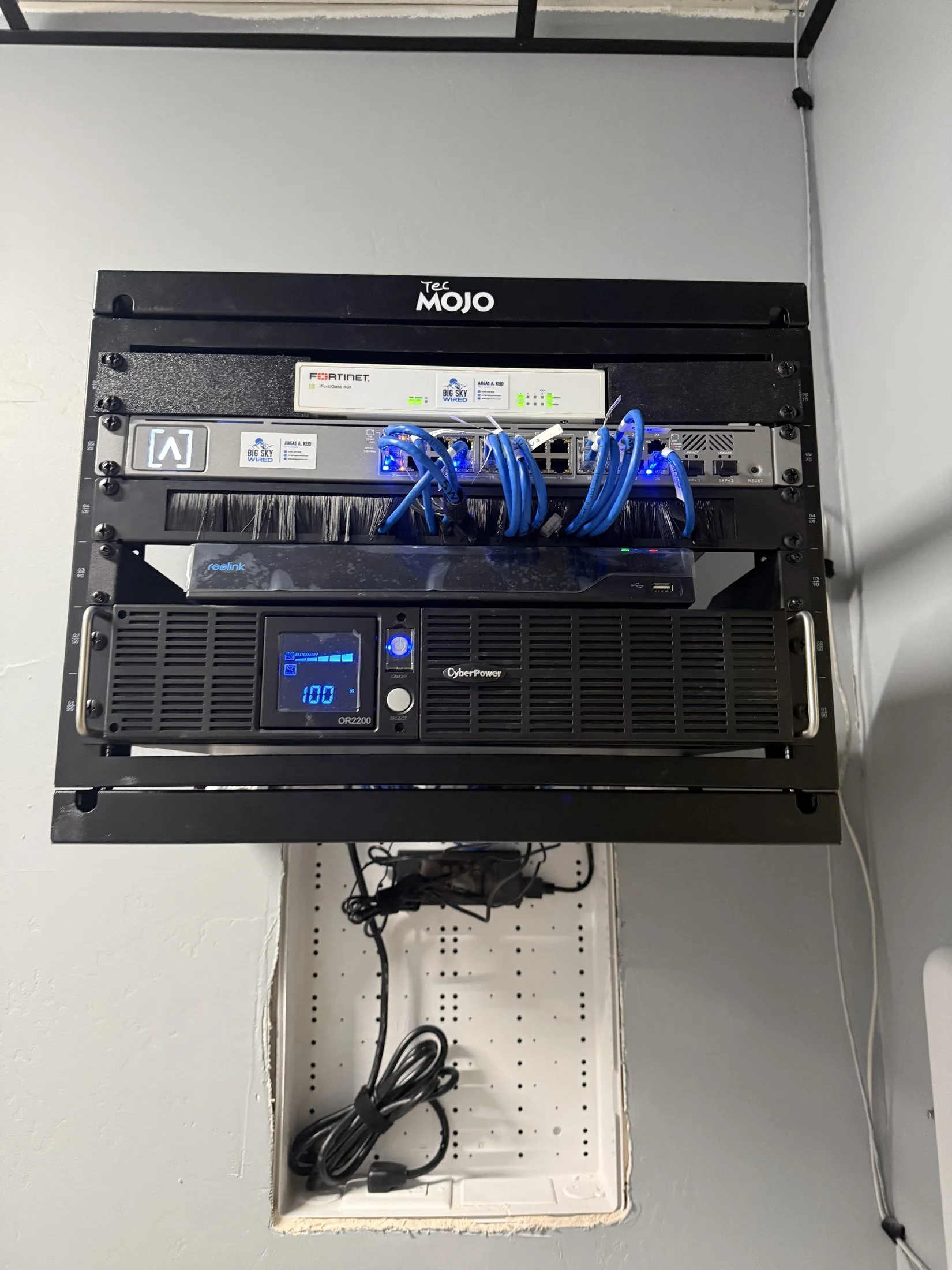 Finished wall rack with firewall, switch, and UPS installed by Big Sky Wired