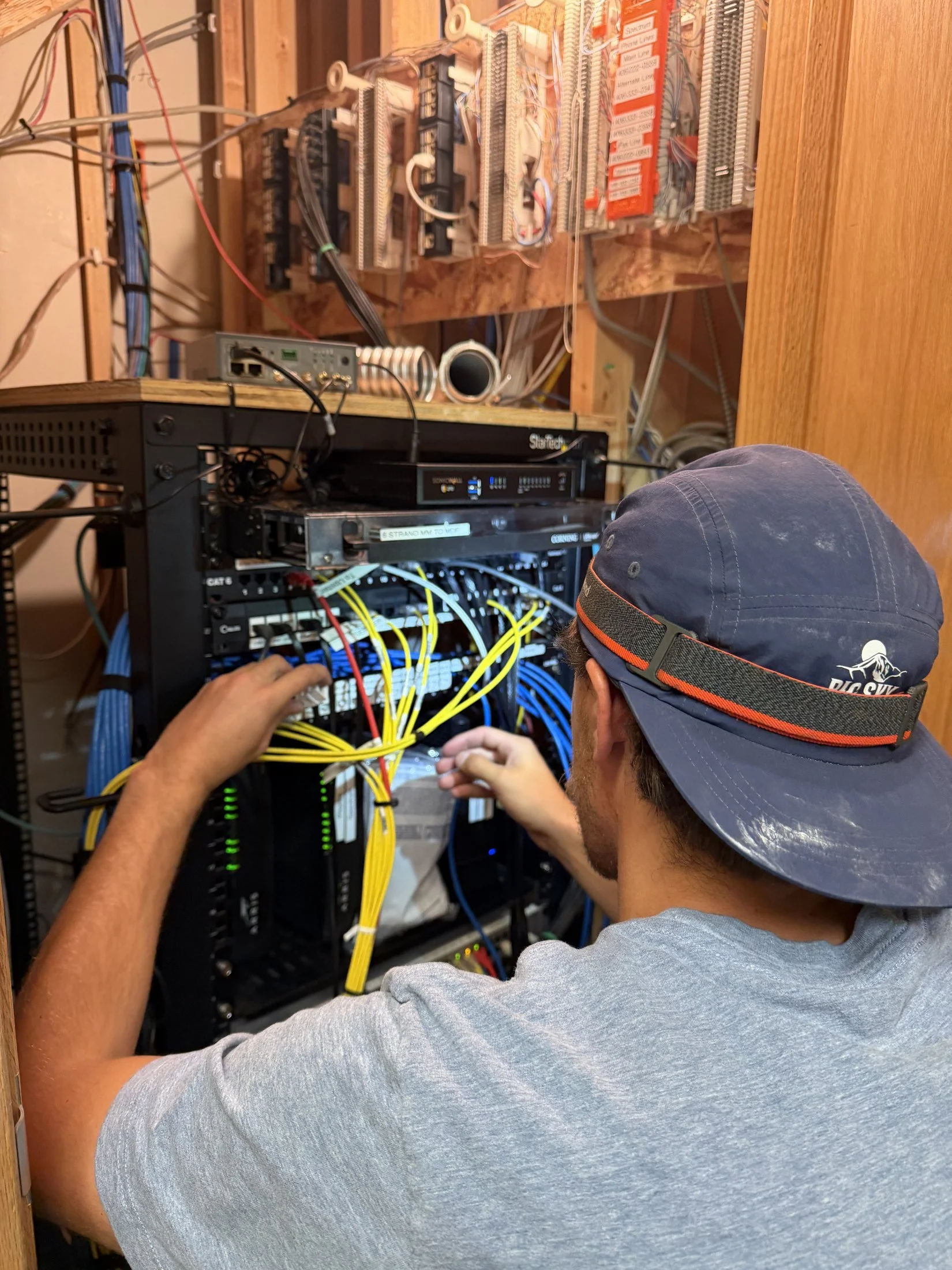 Big Sky Wired technician terminating cabling at a network rack