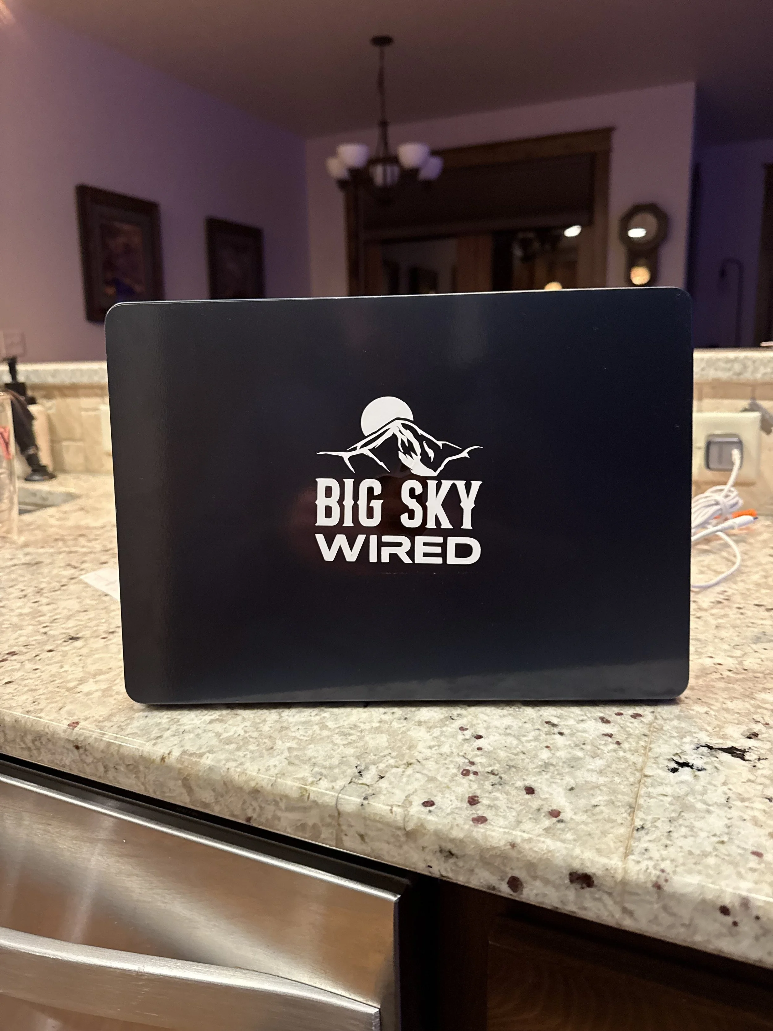 Big Sky Wired branded laptop on a kitchen counter