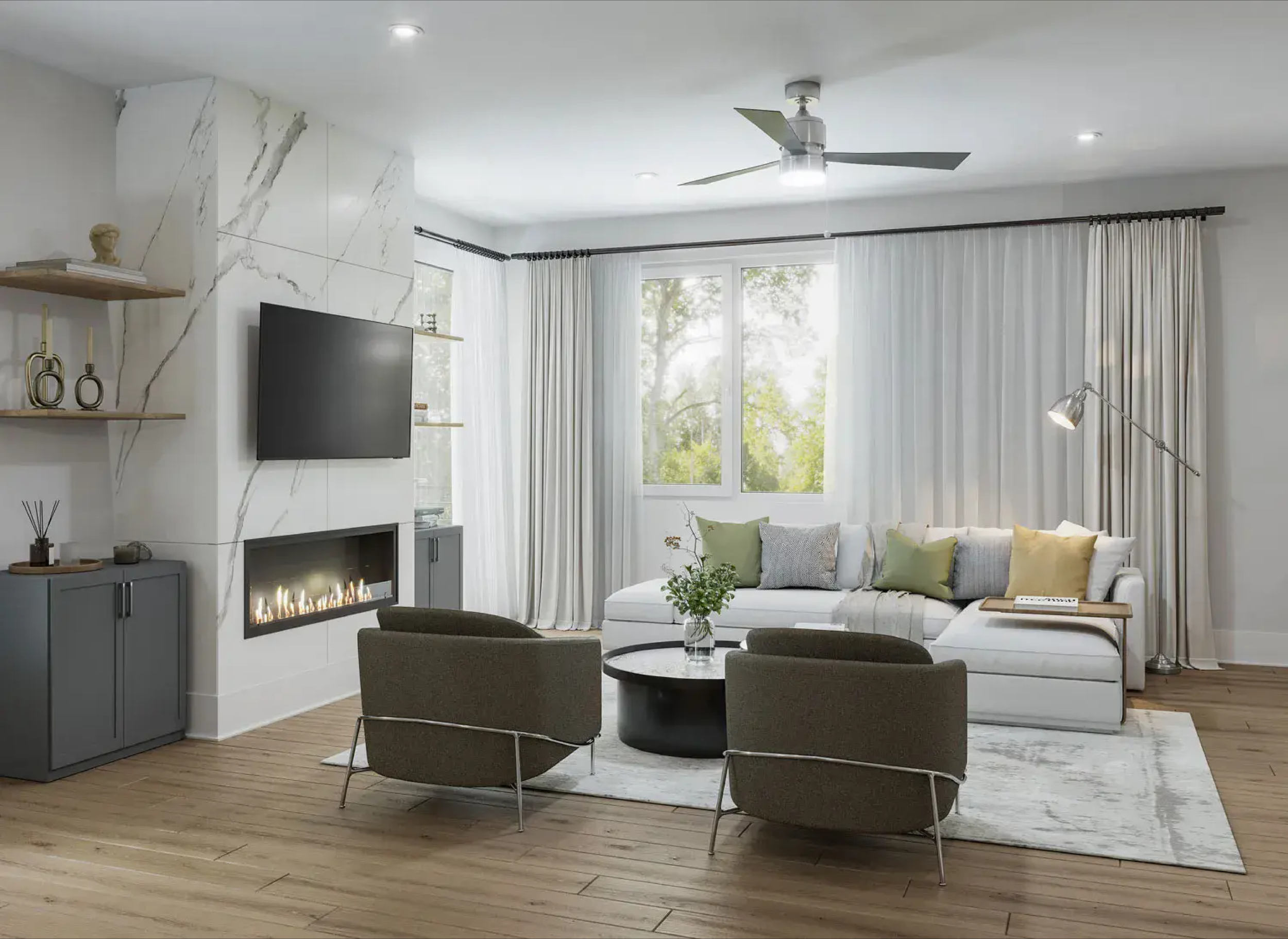 Elegant living room with quartz-accented fireplace, wall-mounted TV, cozy sectional sofa, large windows with sheer curtains, modern armchairs, and wood flooring; bright, inviting space with contemporary decor and ceiling fan