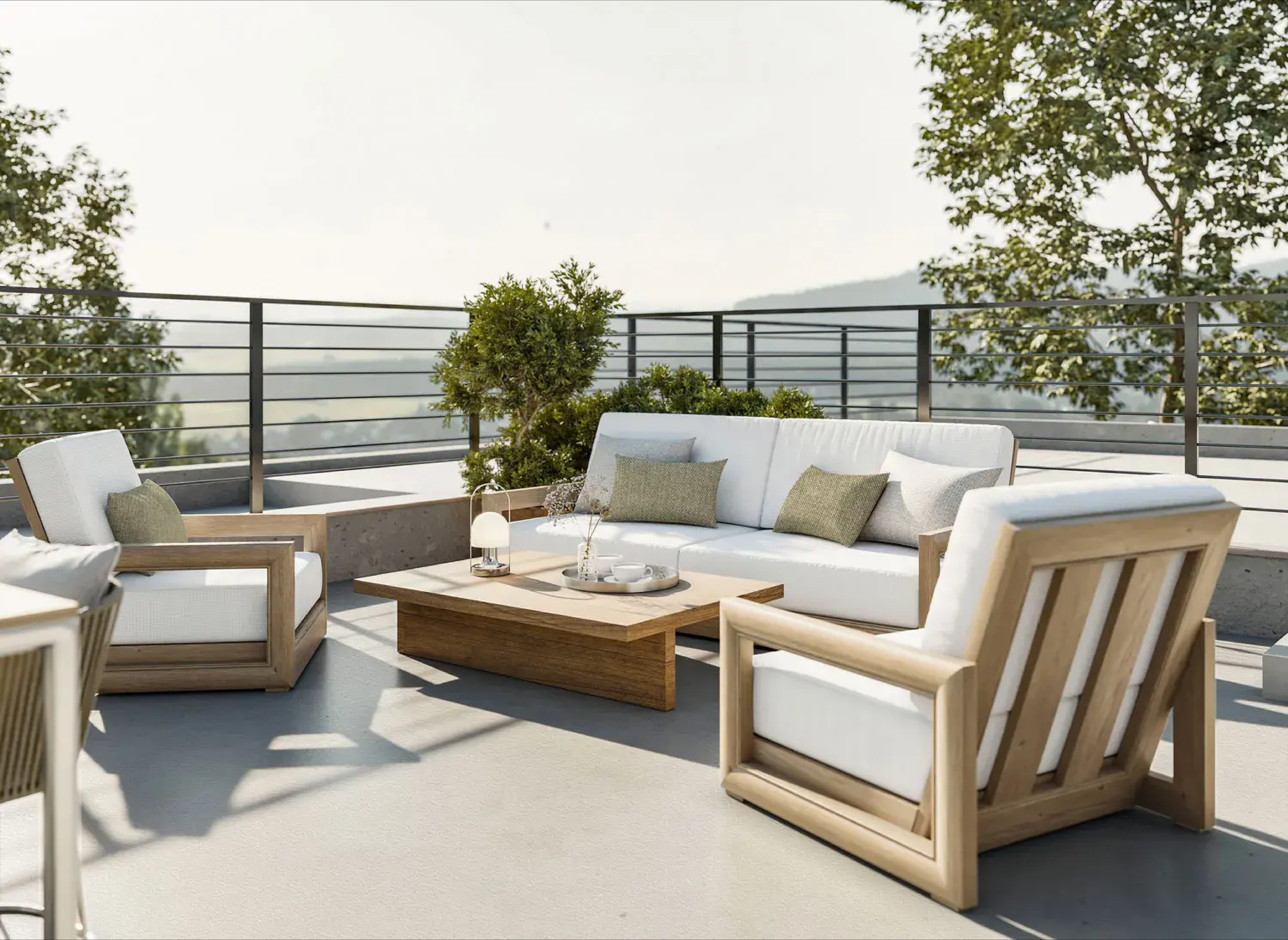 Rooftop patio with woven outdoor seating, neutral cushions, and patterned pillows, offering panoramic views of natural landscape; modern metal railing enhances open, serene atmosphere.