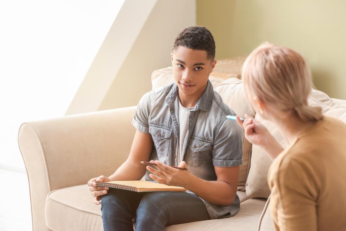 Child or adolescent receiving individualized therapy focused on behavioral support, emotional regulation, and developing lifelong skills for confidence and stability. Hispanic therapist, counselor