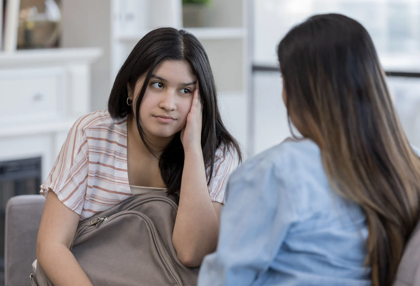 A supportive parent talking with their teenager about the upcoming school year, illustrating the importance of validating teen anxiety and creating a practical coping plan to manage stress before the first day of class.
