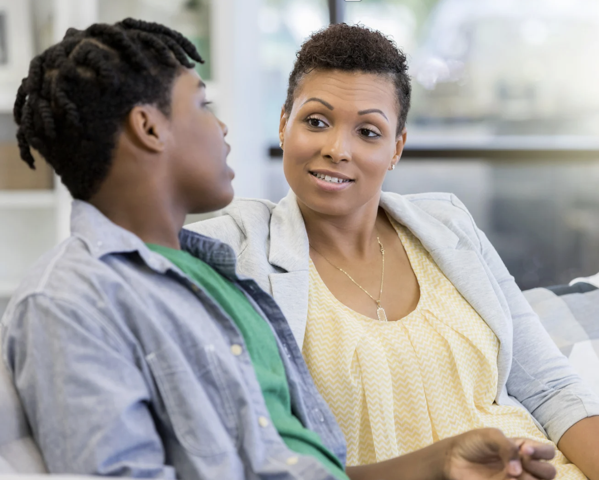 Teen sitting with a supportive parent, representing adolescent mental health, anxiety, depression, and family communication support at Prospering Minds Counseling in Carol Stream, IL.