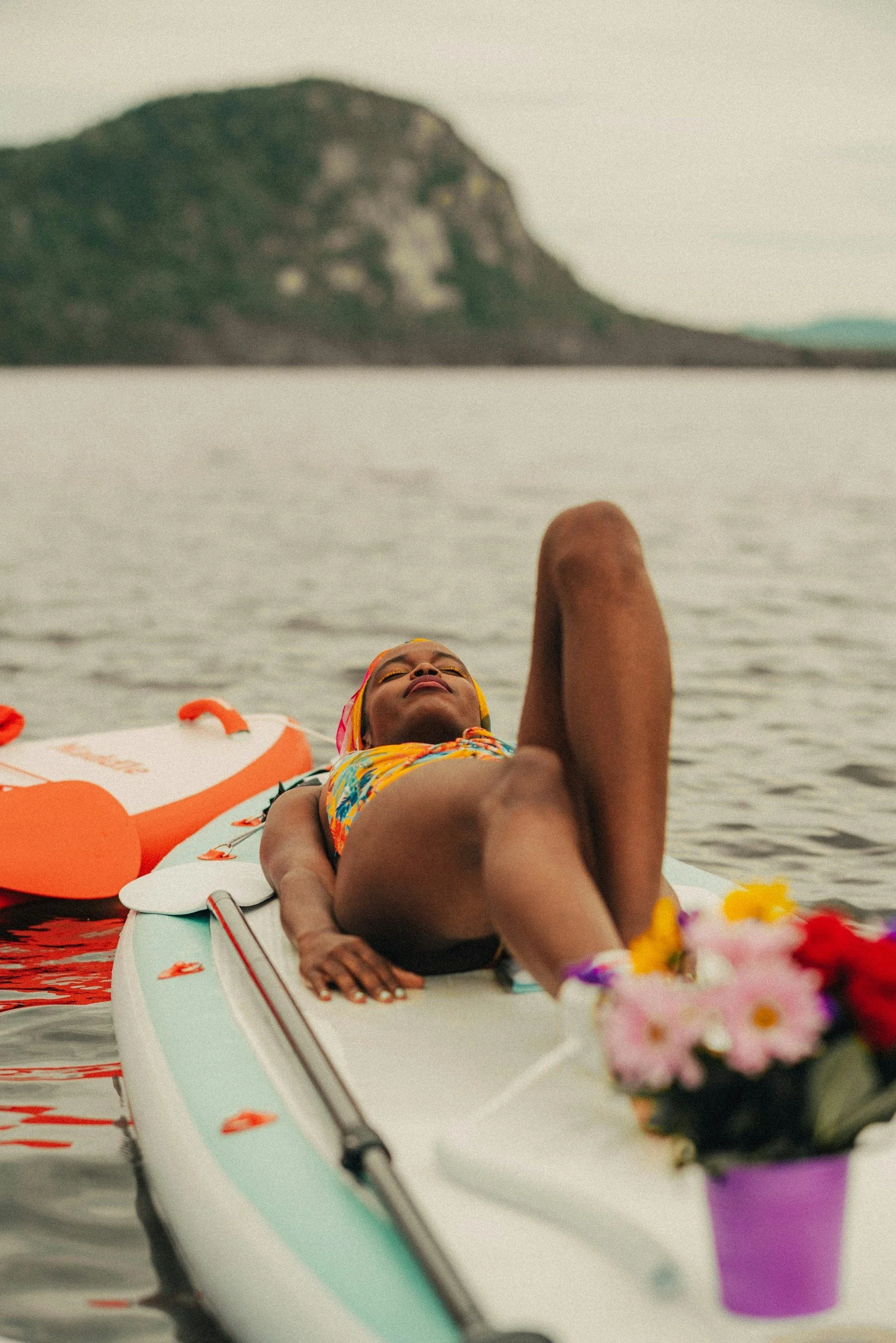 Paddleboarding gliding across a calm lake during a somatic healing retreat focused on nervous system repair and emotional regulation. Outdoor therapy meets nature immersion for overwhelmed high-achievers.