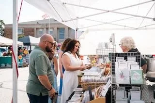  Amy Martin talking to an artist during the festival. 