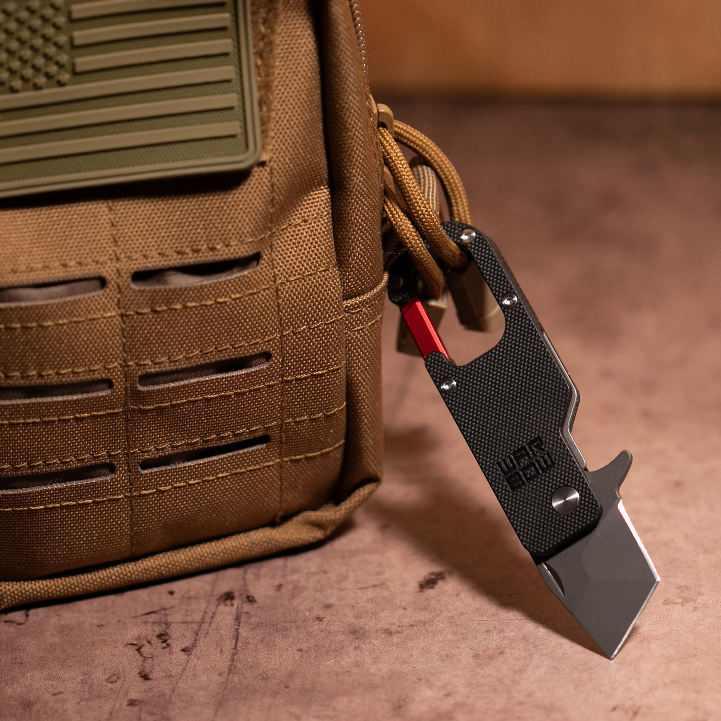 Warbow Mini Tanto Carabiner clipped to a tactical Molle bag