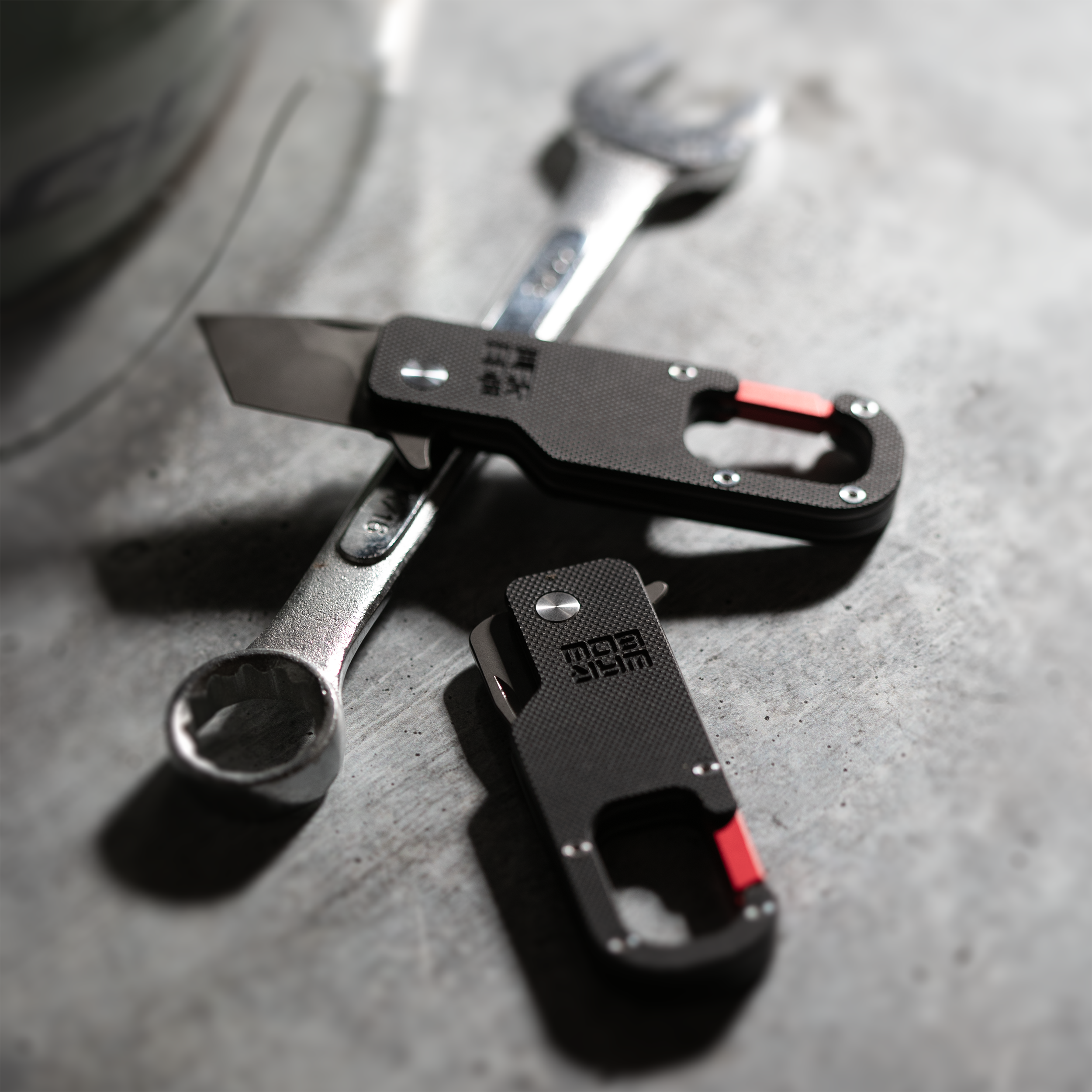Warbow Mini Tantoo Carabiners on a steel surface with a wrench