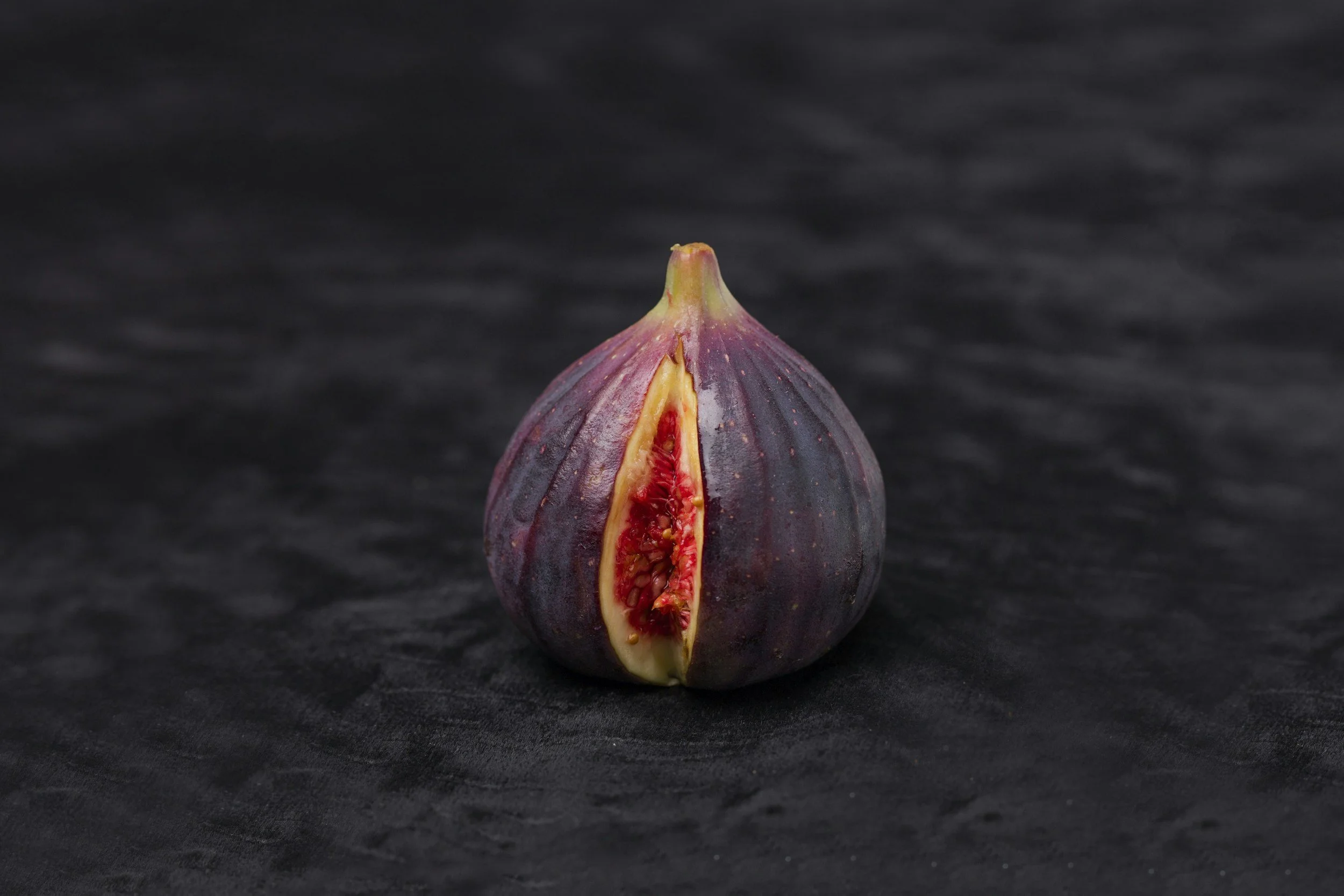 A fig cut open to represent a uterus and lining.