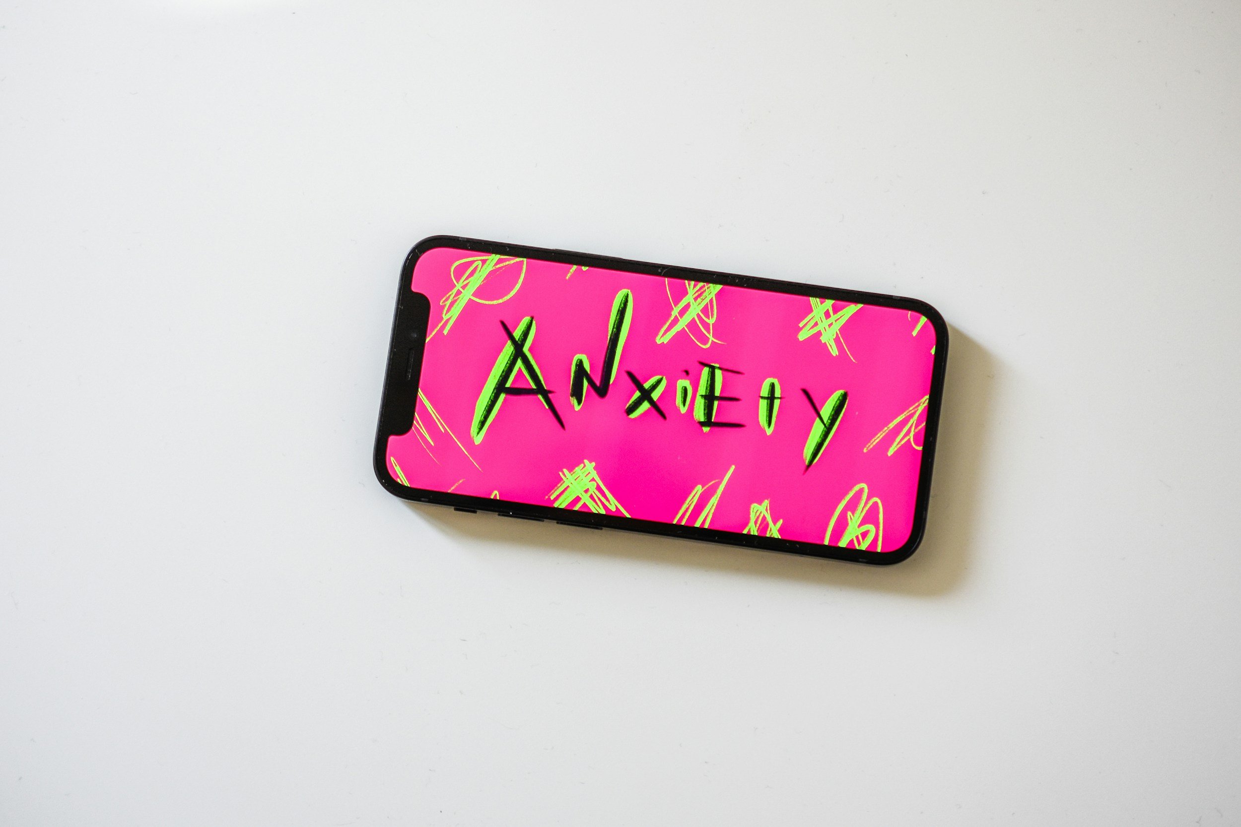 A phone with the word anxiety on the home screen