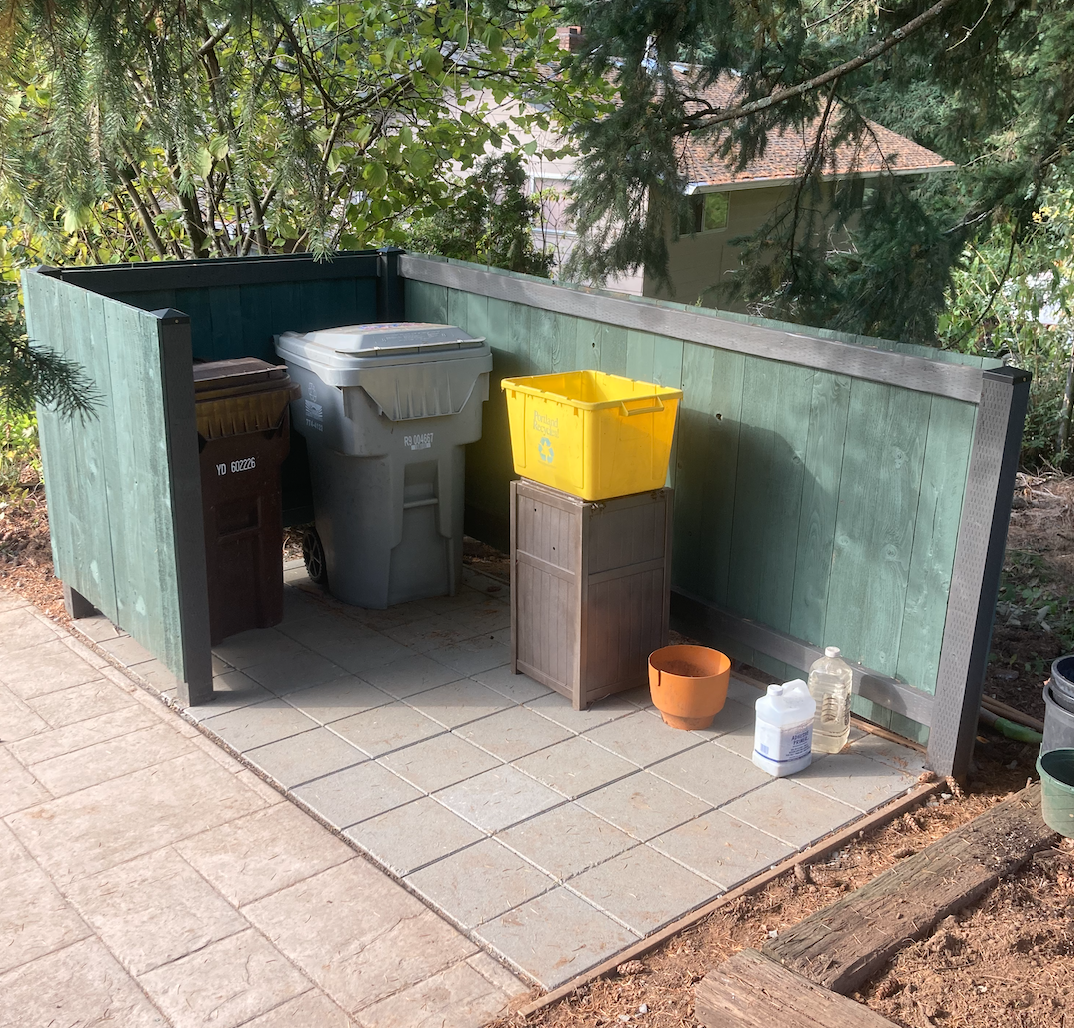 Paver patio and fence enclosure for trash area
