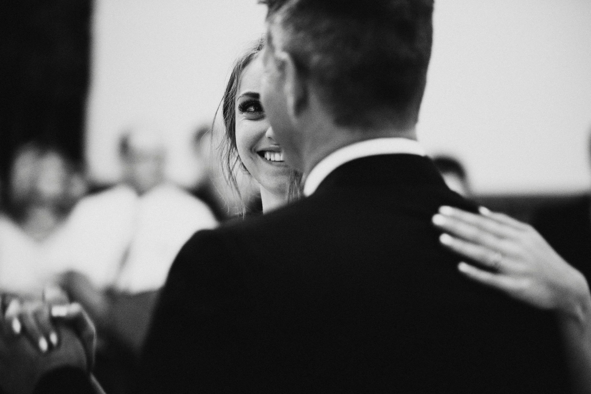 A black and white documentary photograph of a bride and her father dancing by Josie Macbeth.
